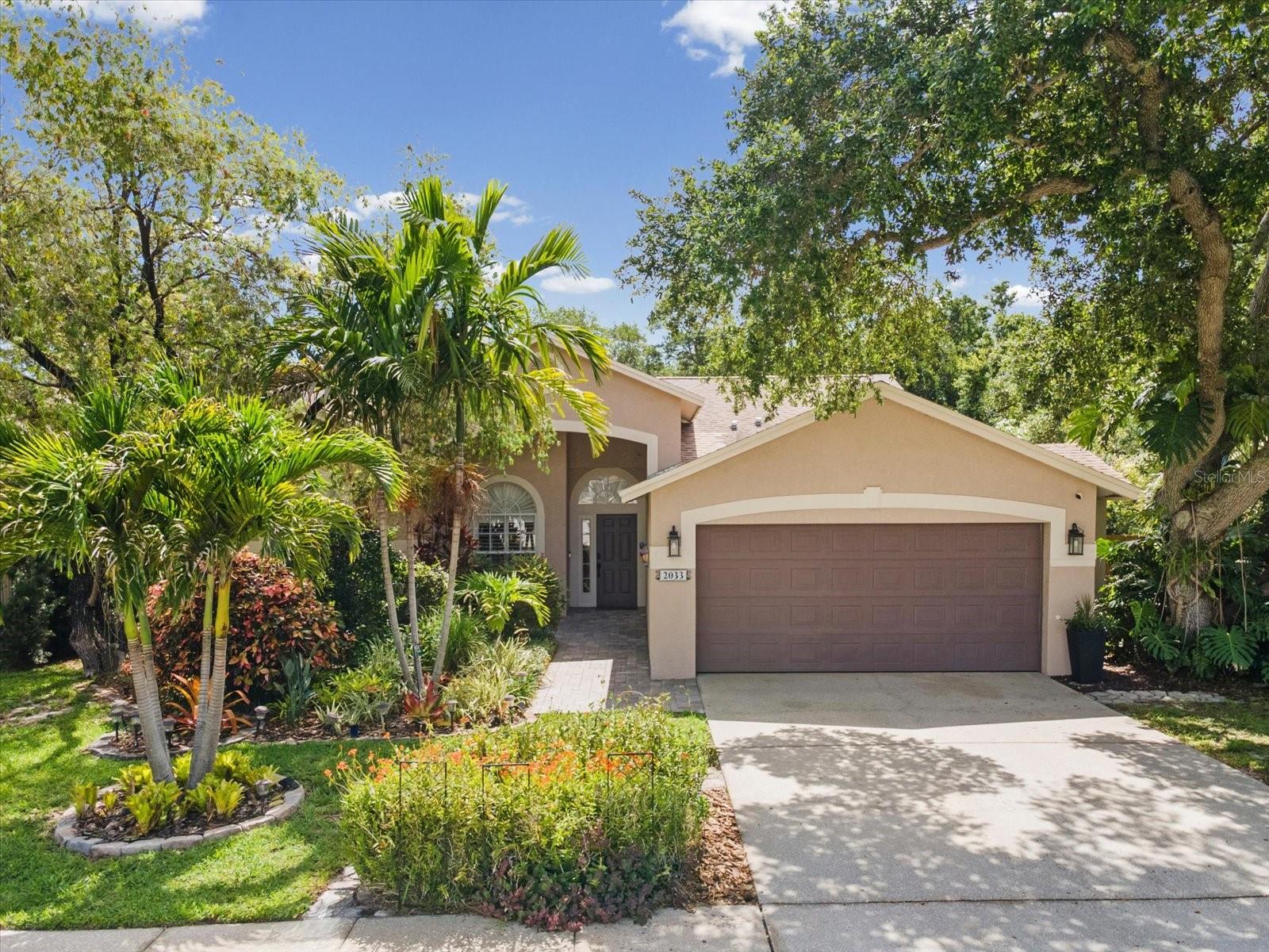 Welcome to your PRIVATE tropical retreat in the highly sought-after Long Branch Creek community. From the moment you arrive, the inviting front porch, paver walkway, Christmas palms, and lush landscaping create a peaceful escape while remaining in central Clearwater. 

Beautifully updated and thoughtfully designed, this 4-bedroom PLUS OFFICE home features an open split floor plan with knockdown ceilings, plantation shutters, natural stone finishes, and seamless indoor-outdoor living spaces ideal for entertaining and everyday living. The home also offers mobility-friendly features including a flush front entry, spacious room flow, open-concept living areas, and an accessible walk-in shower with built-in safety features.           

                                                                                                                                                                                                                                                                                                  The chef’s kitchen showcases granite countertops, travertine flooring, natural stone backsplash, stainless steel appliances, accent shiplap wall, coffee bar with granite top, pull-out pantry storage, spice drawers, and abundant custom cabinetry. The spacious family room centers around an electric fireplace with stone tile surround and custom mantel. The dedicated OFFICE with custom built-ins provides two work-from-home spaces . A mudroom with built-in storage and an inside laundry room with built-in ironing board add everyday convenience.                                                                                                    

The SPA-INSPIRED primary suite serves as a private retreat featuring a spacious walk-in closet, jetted soaking tub, and oversized shower designed for two with dual shower stations, rainfall shower, built-in bench seating, and four invigorating body jets.

Step outside to the RESORT-STYLE backyard where paver and seashell walkways meander through lush tropical gardens filled with bougainvillea, orchids, and thoughtfully designed outdoor spaces. Discover a pergola with a custom gardening table, a fountain surrounded by greenery, seating areas, a firepit gathering space, and a hidden bench swing tucked among the landscape. Towering areca palms and mature landscaping create privacy, enhanced by no neighbor on one side and a horse property to the rear. Beyond the back fence, the property extends to a second fence line, adding extra outdoor space. A discreet enclosed storage area preserves the garden setting while keeping necessities out of sight.

Additional highlights include an OVERSIZED garage with built-in workbench, pool bath, A/C (2022), Roof (2016), Water Heater (2025), low HOA, and extensive upgrades throughout. Ideally located in central Pinellas County just minutes from Tampa, beaches, airports, Costco, Publix, Sprouts, shopping, dining, and everyday conveniences, this home offers an ideal lifestyle of privacy, comfort, and timeless Florida beauty.