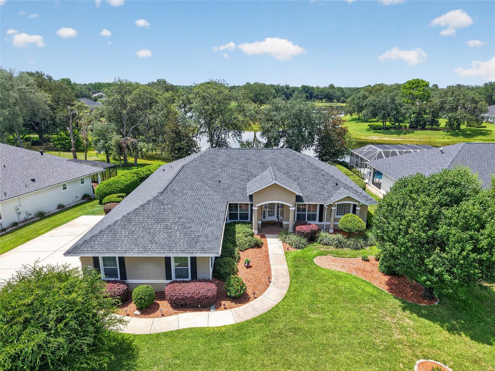 Lakefront living meets championship golf in this custom Biltmore pool home overlooking the 10th green in gated Lake Diamond Golf & Country Club. The three-bedroom, two-bath residence with 2,436 square feet of living space offers striking views of the lake and golf course and has been meticulously maintained, presenting like new. Designed for comfortable living and entertaining, the home features a split floor plan, a three-car garage and a dedicated office or den with a built-in entertainment center. Crown molding enhances the office or den, primary bedroom, dining room and kitchen, while Legacy Plantation shutters add timeless style and privacy to the dining room, den/office. An oversized mitered glass window in the breakfast nook frames lake and golf course views, filling the main living areas with natural light. Outdoor living centers around the newly renovated 12-by-24-foot screened, heated pool, spa and lanai. The lakefront setting and golf course backdrop create an inviting environment for relaxing or entertaining throughout the year. Lake Diamond Golf & Country Club features an 18-hole championship golf course, clubhouse and pro shop, offering opportunities for golf and recreation within the community. Recent improvements include a new roof in 2024, a new water heater and irrigation well system upgrades completed in 2025, including a new pump, control box, piping and pressure tank. Conveniently located in southeast Ocala, the community provides easy access to shopping, dining, medical facilities, downtown Ocala and Interstate 75.