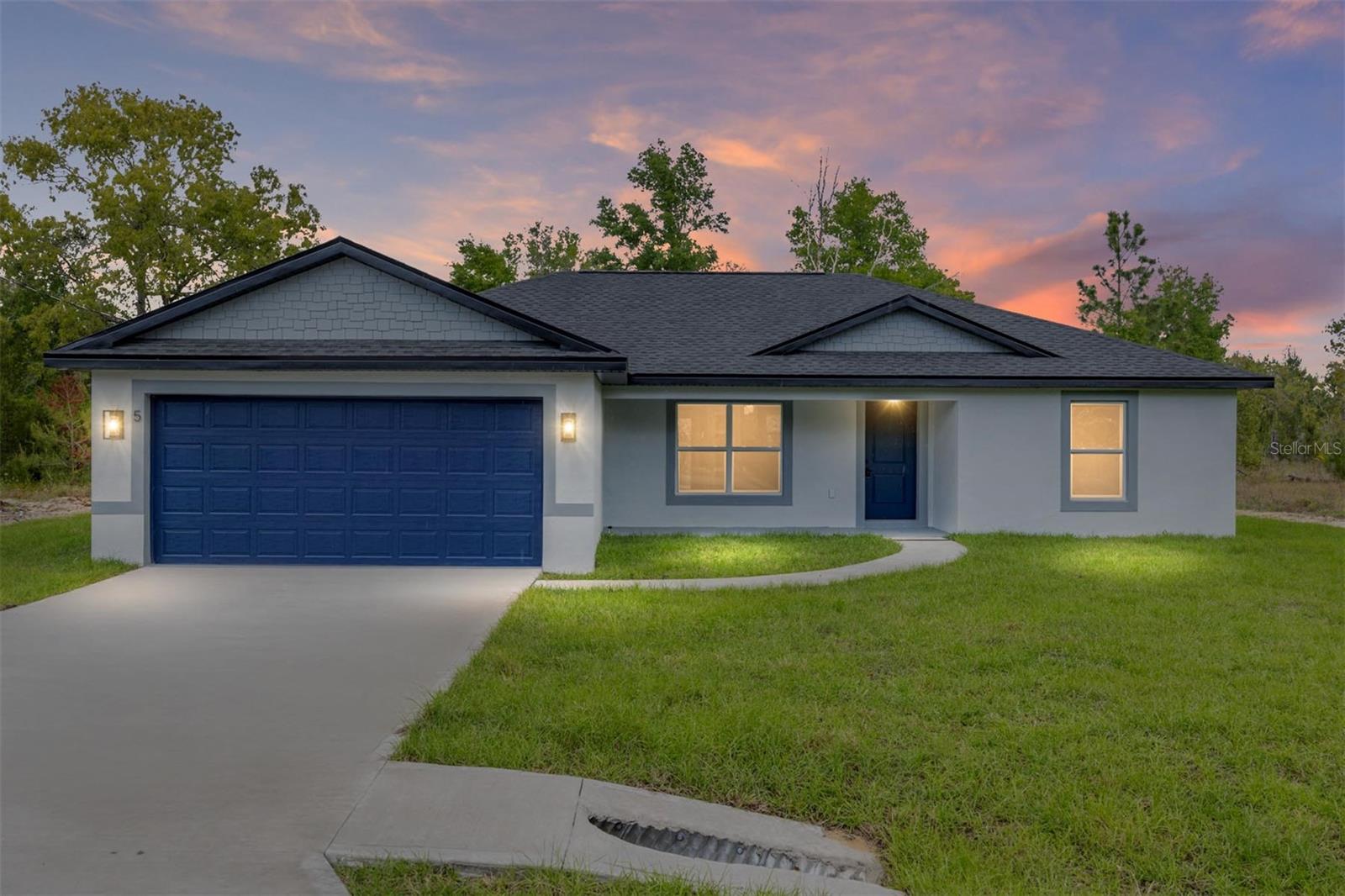 One or more photo(s) has been virtually staged. New Construction Home in Ocklawaha – Modern Comfort and Prime Location

Welcome to this beautiful new construction home located in Ocklawaha, offering the perfect blend of modern design, functionality, and comfort. Featuring 3 spacious bedrooms and 2 full bathrooms, this thoughtfully designed home is built to meet today’s lifestyle needs.

All bedrooms include ceiling fans with remote controls, providing added comfort and convenience. The primary suite offers a private retreat with a generous walk-in closet featuring soft-close doors, while the additional bedrooms also include built-in closets with soft-close features for a refined touch.

The bathrooms are beautifully finished with porcelain tile throughout, and linen/storage closets with metal shelving, combining both style and practicality.

The open floor plan creates a seamless flow throughout the home, enhancing natural light and making the living spaces feel bright and inviting. The spacious living room features an impressive 72-inch low-noise ceiling fan with remote control, perfect for relaxing or entertaining.

The kitchen is truly a standout feature, showcasing elegant Luxury Quartz countertops with waterfall edges on both sides, solid wood cabinetry, modern-style light fixtures, and all appliances included, making the home completely move-in ready. The dining area is enhanced with contemporary lighting, adding warmth and sophistication to the space.

The laundry room includes a stylish farmhouse-style door with a soft open/close system, adding both charm and functionality.

Additional highlights include an oversized 2-car attached garage with enough depth to accommodate a truck with an 8-foot bed. The garage also features staircase access to an additional overhead storage area, offering valuable extra storage space.

Conveniently located near major roads and well-regarded schools, this home is an excellent choice for families or anyone seeking a peaceful yet well-connected location.

This property combines quality construction with upscale finishes and thoughtful details, creating a home that is both stylish and practical. An exceptional opportunity you do not want to miss.