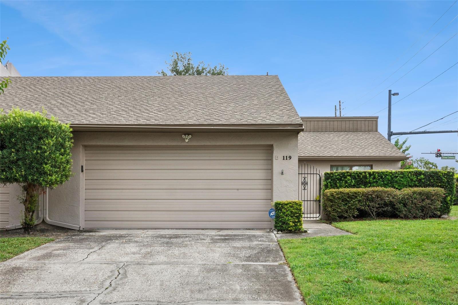 Welcome home to this move-in ready 3-bedroom, 2-bathroom townhome nestled in the desirable Lake of the Woods community in Fern Park. Ideally situated on an end unit at the end of a dead-end street, this home offers added privacy with minimal traffic while providing access to fantastic community amenities, including a clubhouse, swimming pool, and fitness center.

A spacious, gated front courtyard creates a warm and private entrance while offering the perfect space for outdoor entertaining, gardening, or relaxing. Inside, the welcoming foyer features a large coat and utility closet and opens into an expansive combination living and dining room, creating an ideal layout for both everyday living and hosting guests.

The dining area flows seamlessly into the kitchen, where you'll find abundant cabinetry and countertop space, room for a cozy bistro table, and convenient access to the attached two-car garage. Sliding glass doors from the kitchen lead directly to the front courtyard, making outdoor dining and indoor/outdoor entertaining effortless.

At the back of the home, a spacious Florida room is lined with double windows that flood the space with natural light, creating the perfect spot for a second living area, home office, or sunroom.

Neutral paint and attractive wood-look tile flooring throughout make this home truly move-in ready. The private bedroom wing features a generously sized primary suite, two spacious secondary bedrooms, and an updated guest bathroom. All three bedrooms offer large closets for ample storage. Both bathrooms have been refreshed with upgraded vanities, while the guest bath features a shower/tub combination and the primary bath boasts a large walk-in shower.

Conveniently located near shopping, dining, major roadways, and everything Central Florida has to offer, this beautifully maintained home combines comfort, privacy, and low-maintenance living in one of Fern Park's most established communities.