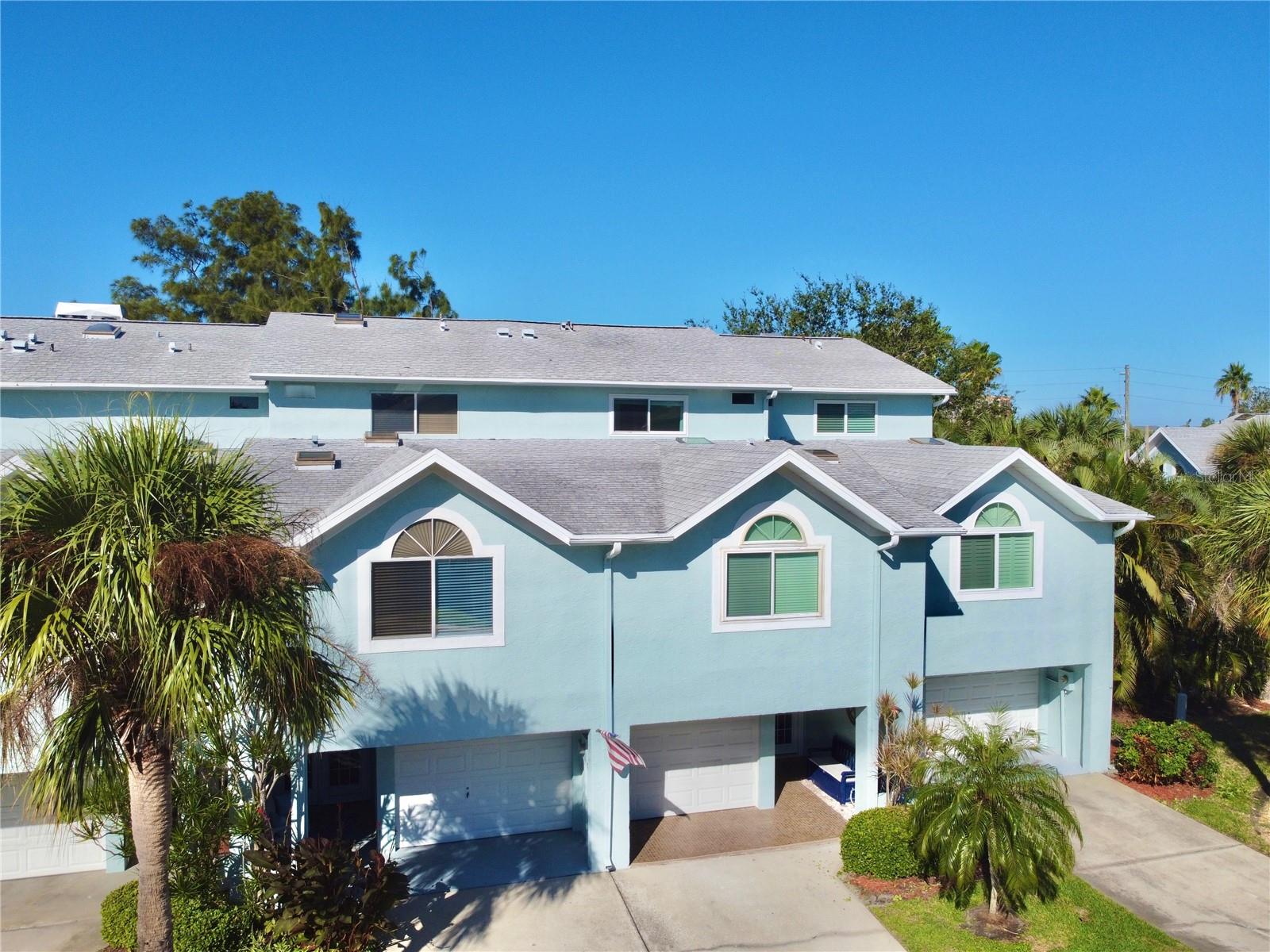 Nestled within the desirable Curlew Landings South community, this thoughtfully renovated townhome has been beautifully maintained and is move-in ready. The tiled covered entry with double French doors opens to a bright and inviting coastal retreat. The first floor features a welcoming foyer and versatile bonus room leading to a private tropical backyard, a rare feature for a beach townhome. Enjoy outdoor living on the covered patio with a grill area, perfect for relaxing or entertaining. The garage provides excellent storage and a new hurricane-rated impact door. Inside, wide-plank luxury vinyl flooring adds durability and coastal style. The main living level showcases an open-concept layout with abundant natural light. The remodeled kitchen includes two-tone quartz countertops, soft-close cabinetry, new Frigidaire stainless steel appliances, and a glass tile backsplash. The living and dining areas feature skylights and sliding glass doors opening to a deck overlooking a peaceful nature preserve for privacy and serene views. The second floor hosts a primary suite with en-suite bath, while the top level offers a second primary suite with balcony, a third bedroom, a second bath, and a laundry closet for convenience. Additional upgrades include hurricane-impact windows and doors throughout. Just a short stroll from the beach, this townhome is perfect as a primary residence, vacation home, or seasonal getaway. Community amenities include a resort-style pool and sundeck, tennis/pickleball courts, and a kayak launch. The association is rebuilding and replacing all balconies, and the $20,000 special assessment has been paid in full, providing peace of mind for the next owner. Experience the best of Indian Rocks Beach coastal living, stylish, low-maintenance, and steps from the sand. Schedule your private showing today!