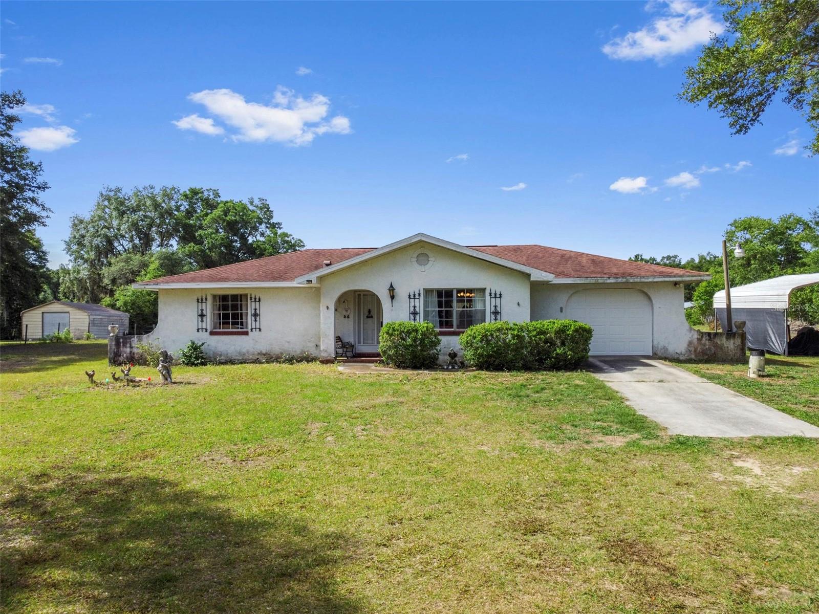 Back on market due to buyer's circumstances. No fault of the property. This 2-bedroom, 2-bath block home sits on 2.4 acres and comes with the updates that matter most — roof (2018), solar panels, and a newer A/C. The property is fully fenced and mostly cleared, with a Covered 2-stall setup ready for your horse, plus a one-car garage for extra storage or workspace and 2 sheds.
Inside, it’s definitely giving “vintage.” Not the trendy kind — the “you can make it exactly what you want” kind. It could use some fresh paint, fresh air, and a little love, but that’s where the opportunity is. You’re not paying for someone else’s updates — you get to create your own.