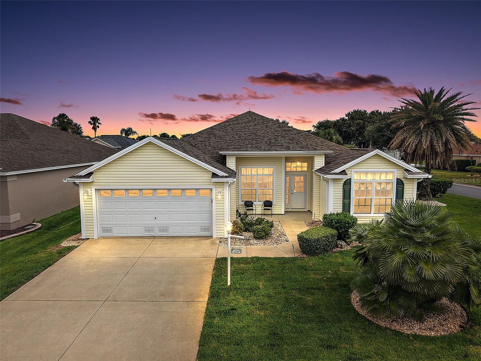 Nestled on a LARGE CORNER LOT in the highly coveted village of POINCIANA, this FABULOUS 3/2 Designer Camelia (Gardenia) boasting an EXPANSIVE ENCLOSED LANAI with MINI-SPLIT and PRIVACY landscaping is a MUST SEE! JUST MINUTES to Lake Sumter Landing and Brownwood Paddock Squares with live nightly entertainment! BOND PAID! ROOF(2021) MATURE landscaping with STONED beds, QUAINT front porch, COVERED entry vestibule, and a French door with retractable screen sidelight and transom window welcome you in to a GENEROUS foyer with TILE flooring and WAINSCOTING. An OPEN CONCEPT layout features HIGH VAULTED CEILINGS adorned with CROWN MOLDING creating a SPACIOUS main living area. The STUNNING kitchen boasts WHITE cabinetry with a corner shelf, GRANITE countertops, STAINLESS appliances, DOUBLE OVEN, built-in PANTRY, ROLL-OUT shelving, and convenient EAT-IN breakfast bar. For casual dining, the dinette area, sits adjacent to the kitchen featuring DOUBLE windows inviting plenty of NATURAL LIGHT. The FORMAL dining room is graced by OPULENT columns, WAINSCOTED walls, and LUXURY VINYL PLANK flooring while the living room features FOUR-PANEL sliding glass doors that open to the EXPANSIVE 20'x17' ENCLOSED LANAI. Designed for year-round enjoyment, this FABULOUS space boasts TILE flooring, MINI-SPLIT, and approximately 340sf of additional living area surrounded by MATURE PRIVACY landscaping, creating the perfect setting for relaxing or entertaining! The primary bedroom boasts a VAULTED ceiling, LAMINATE flooring, and TWO WALK-IN closets. One is CUSTOMIZED and the other offers a built-in SAFE. Its en-suite bathroom features WHITE corner cabinetry with DUAL sinks and GRANITE top, MAKE-UP vanity, TILED WALK-IN shower with FRAMELESS glass, and LINEN closet. Adjoining the primary bedroom, is an 8’x8’ BONUS ROOM - perfect for a HOME OFFICE. A SPLT FLOOR plan places two additional bedrooms and a second bath near the front of the home behind a POCKET DOOR, ensuring plenty of PRIVACY for guests. Bedroom two features LAMINATE flooring, VAULTED ceiling, and built-in closet. The second bath has TILE flooring, WHITE vanity with GRANITE top, TILED tub and shower combo, and hall LINEN closet. The third bedroom (no closet) also boasts LAMINATE flooring and VAULTED ceiling. An INTERIOR laundry room features WHITE cabinetry, shelving, and built-in utility sink with GRANITE top. The TWO-CAR GARAGE offers attic access with stairs, suspended STORAGE shelving, whole-house Nova water filtration system, and PLENTY of room for PARKING! DON’T MISS YOUR OPPORTUNITY to make this FANTASTIC HOME YOUR OWN! The Village of Poinciana is JUST MINUTES from BOTH Lake Sumter Landing and Brownwood town centers - where you'll enjoy EASY ACCESS to live nightly entertainment, shopping, and dining! Nearby regional recreation centers include Seabreeze and Lake Miona with its gorgeous walking trails! Also close by are Poinciana, Allamanda, and Hibiscus neighborhood pools and recreational centers.  For golf enthusiasts, Cane Garden Country Club is just a short drive away, featuring a well-equipped pro shop and 27 holes of challenging championship golf on the Jacaranda, Hibiscus, and Allamanda courses. Nearby 466 and 466A feature a PLETHORA of shopping, restaurants, banks, medical and more! PLEASE WATCH OUR WALKTHROUGH VIDEO of this INCREDIBLE HOME in an IDEAL LOCATION and CALL TODAY to schedule your Private Showing or Virtual Tour!