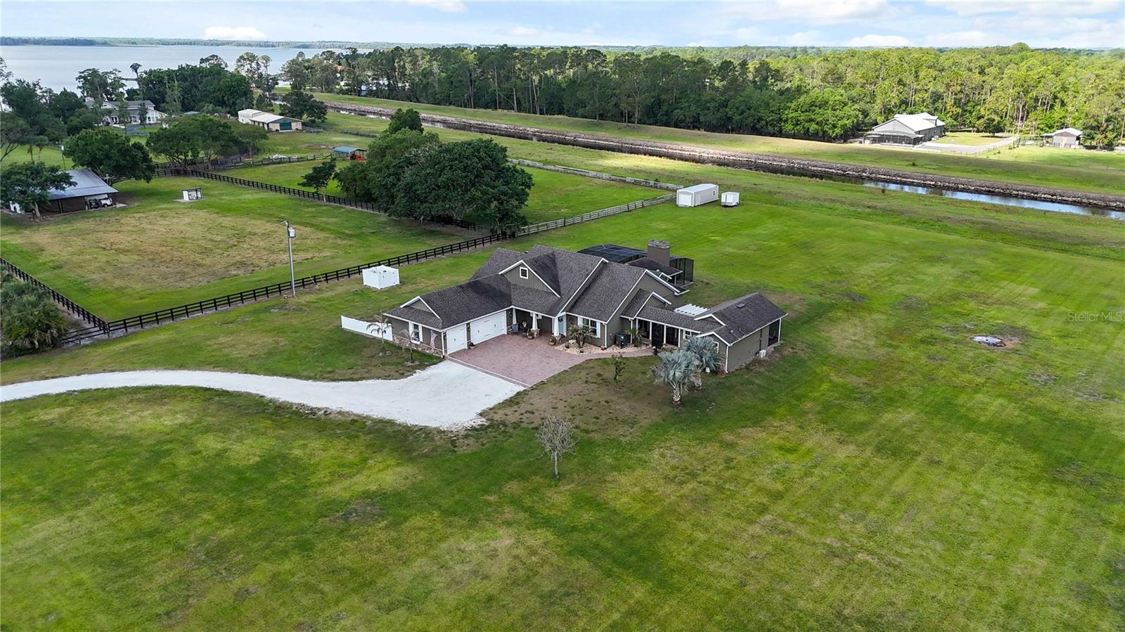 Welcome to an extraordinary opportunity at 4901 Manor House Lane in beautiful St. Cloud — located in one of Central Florida’s rare private fly-in communities! This stunning 4+ acre estate offers a lifestyle that is nearly impossible to find anywhere else in Florida, combining both private runway access and lakefront living in one incredible property.

Adjoining the community runway, this one-of-a-kind property is perfect for aviation enthusiasts and those seeking privacy, luxury, and adventure. Enjoy approximately 350 feet of deeded water frontage with direct access to Lake Gentry and the highly sought-after Southern Chain of Lakes in Osceola County, creating endless opportunities for boating, fishing, and waterfront recreation.

The beautifully designed custom home features 5 spacious bedrooms and 3 full bathrooms with exceptional craftsmanship and upscale finishes throughout. Inside, you’ll find custom upgraded countertops, cabinetry, upgraded tile flooring throughout entire home, fixtures, and thoughtfully designed living spaces ideal for both entertaining and everyday comfort.

Step outside to your own private resort-style retreat featuring a stunning outdoor living and kitchen area, perfect for hosting gatherings year-round, along with a built-in swimming pool surrounded by the peaceful beauty of the property. Additional features include a spacious 3-car garage and a private detached guest house complete with 1 bedroom, 1 bathroom, and a mini kitchen — ideal for guests, extended family, or additional income potential.

Conveniently located just 30 minutes south of Lake Nona Medical City and only 30 minutes from Florida’s beautiful East Coast beaches, this property offers the perfect balance of luxury, convenience, and recreation.

Properties like this rarely become available — schedule your private showing today before this exceptional estate is gone!