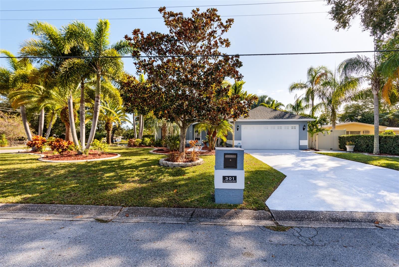 Welcome to your own private paradise! Live the Florida lifestyle and feel like you are at a resort every day in this 3-bedroom, 2.5-bath concrete block home. No Flood Insurance requirements. Skycrest is a quiet neighborhood nestled between schools, shopping and the most popular beach in Pinellas County. The 1/4 acre corner lot is painstakingly manicured with a variety of palm trees and other drought tolerant landscaping. One of the best features of this home is its layout and openness to the lanai and pool area. It's like having an extra living room. The pool and spa are separated from the home by the screen enclosure on the back patio. No detail has gone unmanaged including Pebble Tec coating, brick pavers, outdoor kitchen, built-in fountains to fill the pool, exterior access half bath, pool heat pump and chiller. Yes, chilling for the summer months.  Back inside the home features include real wood flooring, security and camera system, fresh paint, fresh carpet, stainless steel appliances, Solatube brand skylight in the kitchen for extra brightness. Split floor plan offers privacy. The primary bedroom is just off the pool area, through the sliding glass door, and has an ensuite bath with updated travertine shower, sliding glass doors and single vanity. The dark accessories create a very modern look and feel. Other updates include: Front storm door 2023, brand new! Exterior paint 2023. Roof and Fence 2022, with permits. Carpet 2022. Pool updates and heat pump 2021. AC system 2021. This home has received all the TLC you could possibly want. Make it yours and start enjoying it on the very same day! Schedule your private showing today.