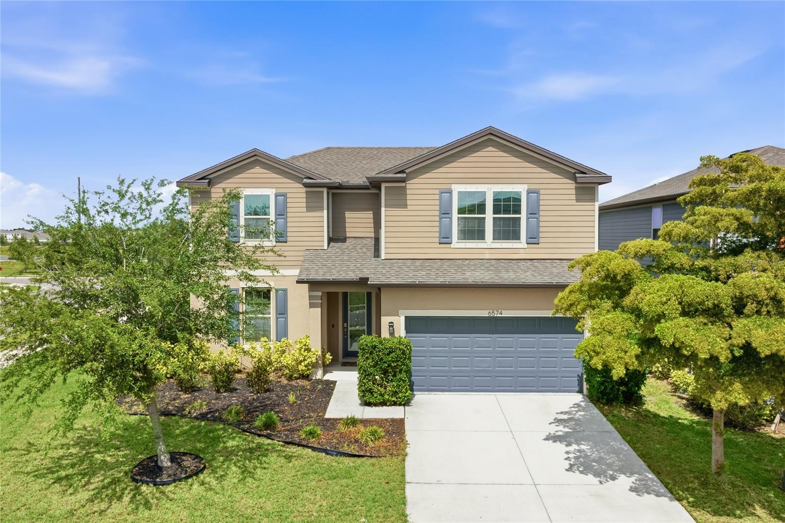 Welcome to 6574 Kenava Loop in the highly sought-after community of Trevesta in Palmetto, Florida! Built in 2019, this spacious and beautifully designed home offers an impressive 2,854 square feet of living space with 4 bedrooms, 3.5 bathrooms, a private den, and a giant loft perfect for a second living area, game room, home theater, or play space. This home also features two primary suites—one conveniently located on the first floor and another on the second floor—offering exceptional flexibility for multi-generational living or guest accommodations.

Step inside to discover an open-concept floor plan featuring expansive kitchen, living, and dining areas designed for both everyday living and effortless entertaining. The oversized kitchen overlooks the main living spaces, creating the perfect gathering spot for family and friends. The living spaces are separated by a charming floor design in the living room. You can also move right in with the updated paint and carpets throughout!

Enjoy the Florida lifestyle outdoors in the large fenced backyard situated on a desirable corner lot with plenty of room to relax, play, or even add your dream outdoor living space. Located in the resort-style community of Trevesta, residents enjoy incredible amenities including a sparkling pool, fitness center, clubhouse, playground, and scenic walking paths. With so much space, this home truly offers the best of comfort, convenience, and Florida living.