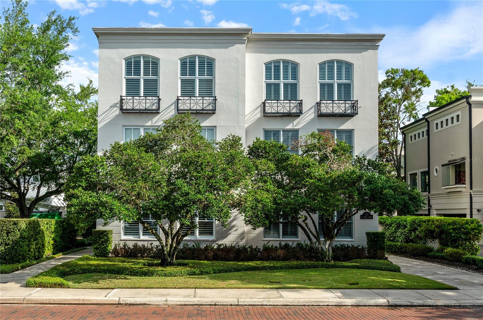 Luxury living in Winter Park 32789 in this well-appointed, fee-simple townhouse just steps from Park Avenue, with no HOA or condo fees. Three-story home features refinished hardwood floors (Knight Flooring), high ceilings, crown moldings and a PRIVATE ELEVATOR for easy access to all levels. The first floor offers a flexible bedroom, currently used as an office and bedroom along with a full bath, spacious laundry room with quartz counters, and plenty of storage. On the second floor, you’ll find an open living and dining area with a gas fireplace, built-ins, plus a large screened porch with a retractable screen and summer kitchen, ideal for entertaining. The kitchen includes stainless appliances, gas cooktop, quartz island, built-in breakfast banquette seating and bar. Upstairs, the third floor has a second bedroom with en-suite bath and a generous primary suite with custom large walk-in closet and a bright Florida room with French doors and lots of windows.  The primary bath features dual granite quartz, lighted mirrors, spa tub and separate shower. Additional highlights include a new roof, A/C systems updated in 2018 and 2024, landscaping improvements, a two-car garage with extra parking spaces, smart home features and a garage refrigerator that conveys. All of this in a highly walkable location near shops, dining, parks, and golf, without the upkeep of a yard. Ava, Boca, Prato, Imperial, Garp & Fuss restaurants are steps away! Saint Margaret Mary is across the street. Enjoy the immaculate public Winter Park Nine Golf Course and historic Casa Feliz for events and concerts and Morse Museum housing the comprehensive works by Louis Comfort Tiffany. Multiple events in the park - Winter Park Arts Festival, holiday events and tree lighting, popcorn in the park movies, live music and more! Furnishings may be available.