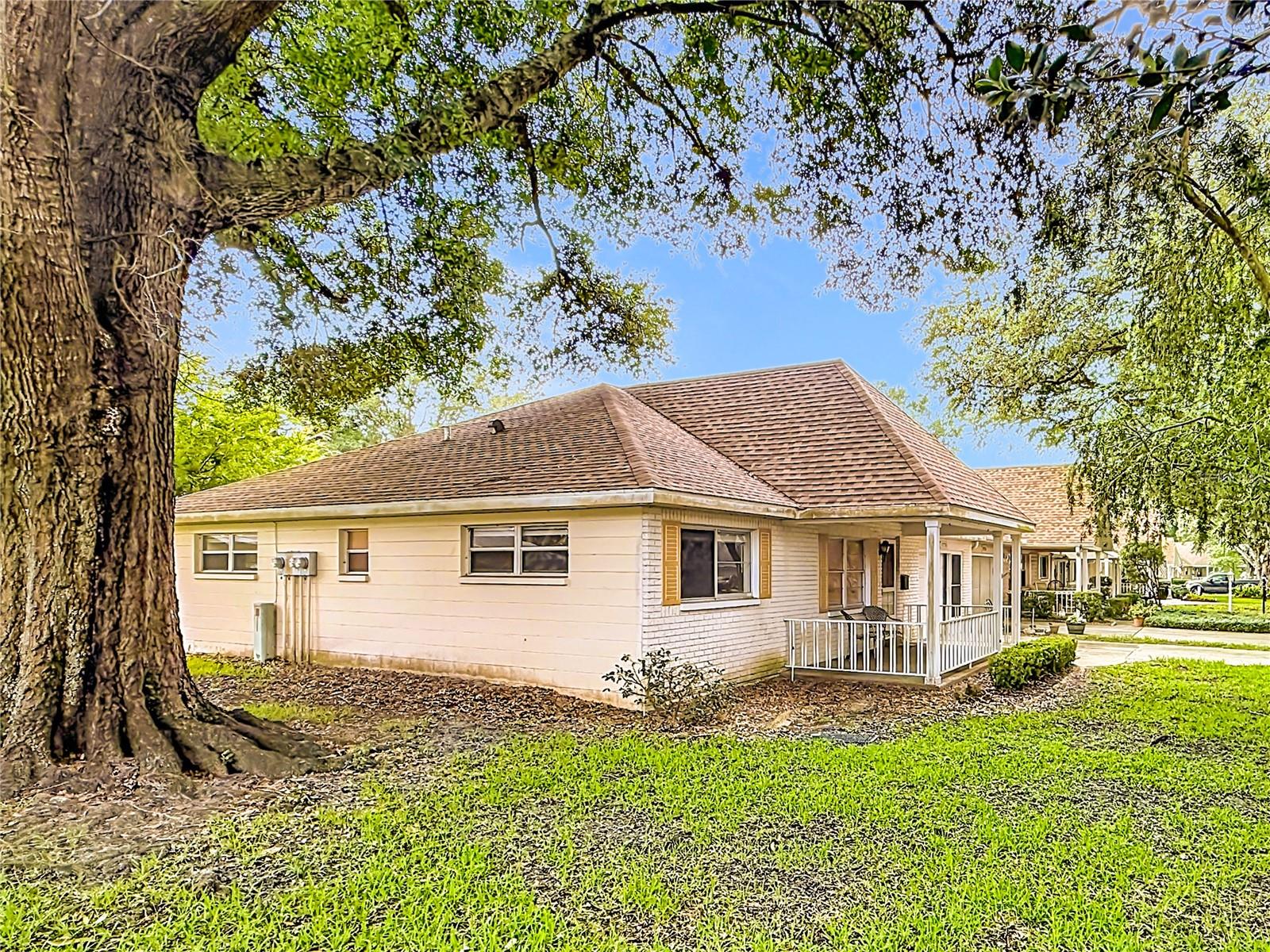 This desirable END UNIT Extended Philadelphian floor plan offers added privacy, abundant natural light, and a serene tree-lined setting in the highly sought-after gated 55+ On Top of the World community in Ocala. Imagine sipping coffee on the front porch while enjoying the peaceful surroundings. This 2 bedroom, 2 bath home has NEW flooring throughout! (2024) The enclosed lanai seamlessly adds 162 sq. ft. of versatile living space, perfect for a home office, sunroom, craft area, or reading retreat.
Enjoy peace of mind with a NEW HVAC system installed in 2023 and a recently REPLACED ROOF in 2021. Both bathrooms feature newer comfort-height toilets, and the primary bath boasts a recently remodeled shower. Spacious closets and a large pantry provide ample storage throughout the home. The oversized 26x16 garage offers generous space for parking, storage, hobbies, or a workshop setup.
Residents of On Top of the World enjoy an unparalleled active-adult lifestyle with resort-style amenities including golf courses, indoor and outdoor pools, fitness centers, pickleball and tennis courts, walking trails, hobby and craft studios, on-site dining, and hundreds of clubs and social activities. Conveniently located close to shopping, medical facilities, restaurants, and Central Florida attractions, this gated community offers the perfect blend of comfort, recreation, security, and low-maintenance living.