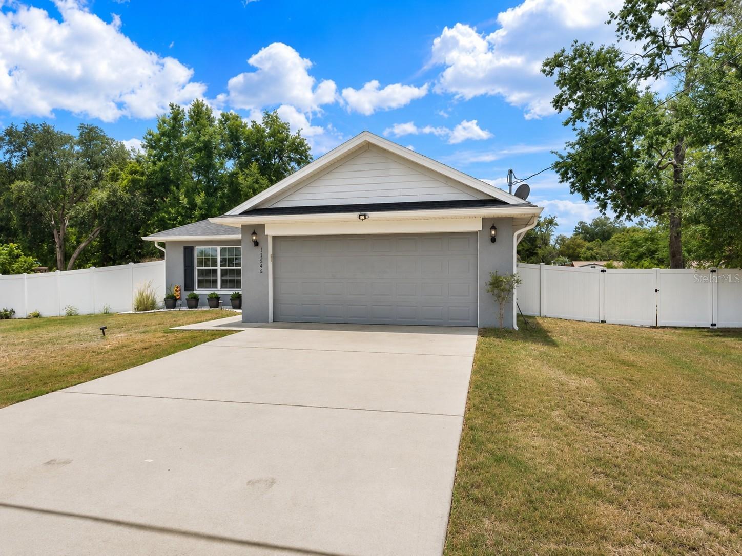 Welcome to your Summerfield retreat, where charm meets tranquility. This thoughtfully designed and impeccably maintained 3-bedroom, 2-bathroom home sits on a spacious 0.29-acre lot. Inside, vaulted ceilings and an open-concept living and dining area create a bright, airy atmosphere from the moment you enter. The spacious owner's suite provides a comfortable retreat, while the well-sized secondary bedrooms offer plenty of room for family, guests, or a home office. Enjoy Florida living year-round from the enclosed lanai overlooking the fully fenced backyard—ideal for pets, play, gardening, or simply unwinding while taking in the the beautiful sunset. Conveniently located just minutes from The Villages and a short drive to Ocala, this home provides easy access to shopping, dining, medical facilities, golf, parks, and everyday conveniences while enjoying a neighborhood that feels removed from it all. Offering the ideal blend of comfort, convenience, and privacy, this Summerfield gem is ready to welcome you home. *Buyer to verify all school and tax information.*