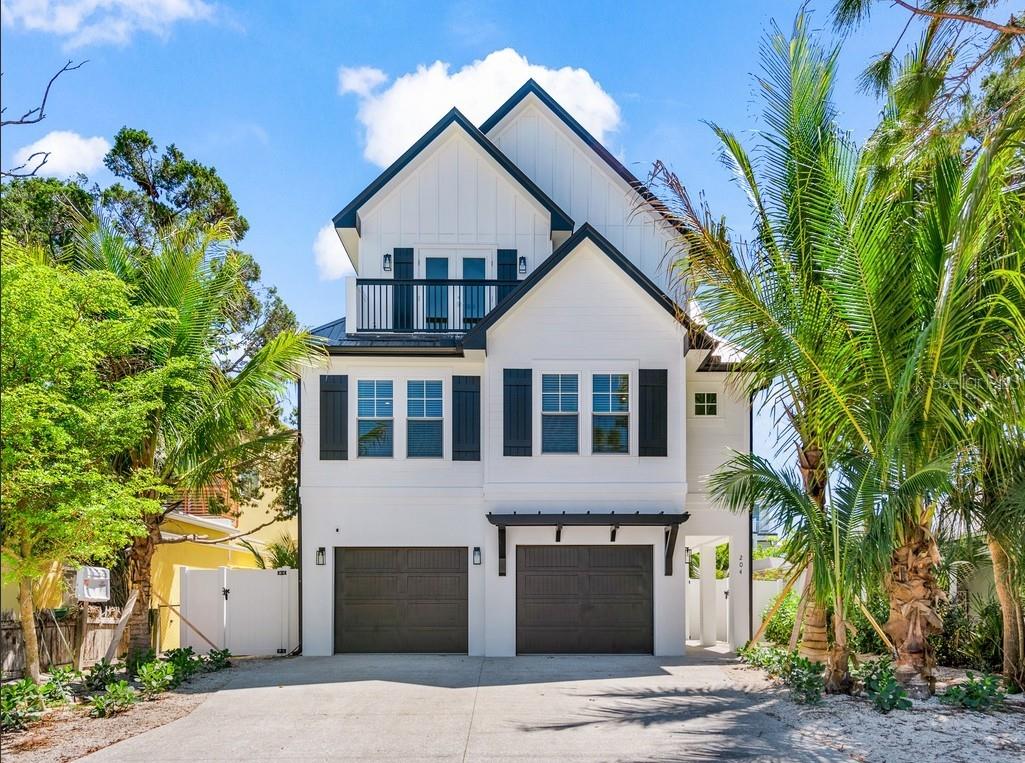 Newly built and exceptionally designed, this stunning 8-bedroom, 8.5-bath custom residence offers the rare opportunity to own a true luxury coastal retreat just moments from the white sand shoreline of Lido Beach and the renowned shopping and dining of St. Armands Circle. Thoughtfully created to accommodate large gatherings without compromising comfort or sophistication, this remarkable home blends elevated craftsmanship, expansive entertaining spaces, and resort-style outdoor living into one unforgettable property. From its striking architectural presence and oversized garage storage to its rich interior detailing, every inch of the home reflects intentional design and quality construction. Wide plank flooring, substantial trim work, custom wall detailing, beautifully finished ceilings, designer lighting, and carefully curated fixtures create a refined coastal aesthetic that feels both polished and welcoming. The main living level was designed with entertaining in mind, offering a seamless open-concept layout where spacious gathering areas, oversized dining space, and outdoor balconies all connect effortlessly around the spectacular chef’s kitchen. Anchored by a dramatic oversized island, the kitchen features custom full-height cabinetry, abundant storage, premium appliances, statement vent hood, striking stone accents, generous prep surfaces, and seating for a crowd, creating a natural centerpiece for everything from casual beach weekends to large holiday gatherings. Multiple living areas throughout the home provide exceptional flexibility for hosting guests, creating media lounges, or offering private escapes, while oversized windows and glass doors fill the interiors with natural light and tropical views. One of the home’s most impressive features is its eight private ensuite bedrooms, each beautifully appointed to provide hotel-style comfort, privacy, and spacious accommodations for family and guests. Designer tilework, custom vanities, elevated plumbing fixtures, and thoughtfully selected finishes continue throughout every bathroom, while the primary suite delivers a true retreat with dramatic architectural detail and a spa-inspired bath designed for relaxation.  The outdoor living experience is every bit as impressive as the interiors. The expansive covered lanai beneath the home creates an additional full-scale entertaining venue complete with shaded lounge seating, dining space, and direct access to the resort-style heated pool and raised spa. A custom waterslide, tropical landscaping, sunning areas, and multiple conversation spaces create a private vacation atmosphere that feels designed for year-round enjoyment. Several covered balconies provide additional places to unwind, while the sprawling rooftop deck captures beautiful Gulf views and coastal sunsets, offering one of the home’s most memorable spaces for gathering, relaxing, and entertaining under the open sky. This is a property built for the way today’s luxury buyer wants to live—spacious, turnkey furnished and effortlessly close to Sarasota’s most iconic coastal destinations. Whether used as an extraordinary personal getaway, an income-producing luxury rental, or a legacy property designed to bring generations together, this residence offers a rare combination of size, quality, location, and lifestyle that is increasingly difficult to find on Lido Key.