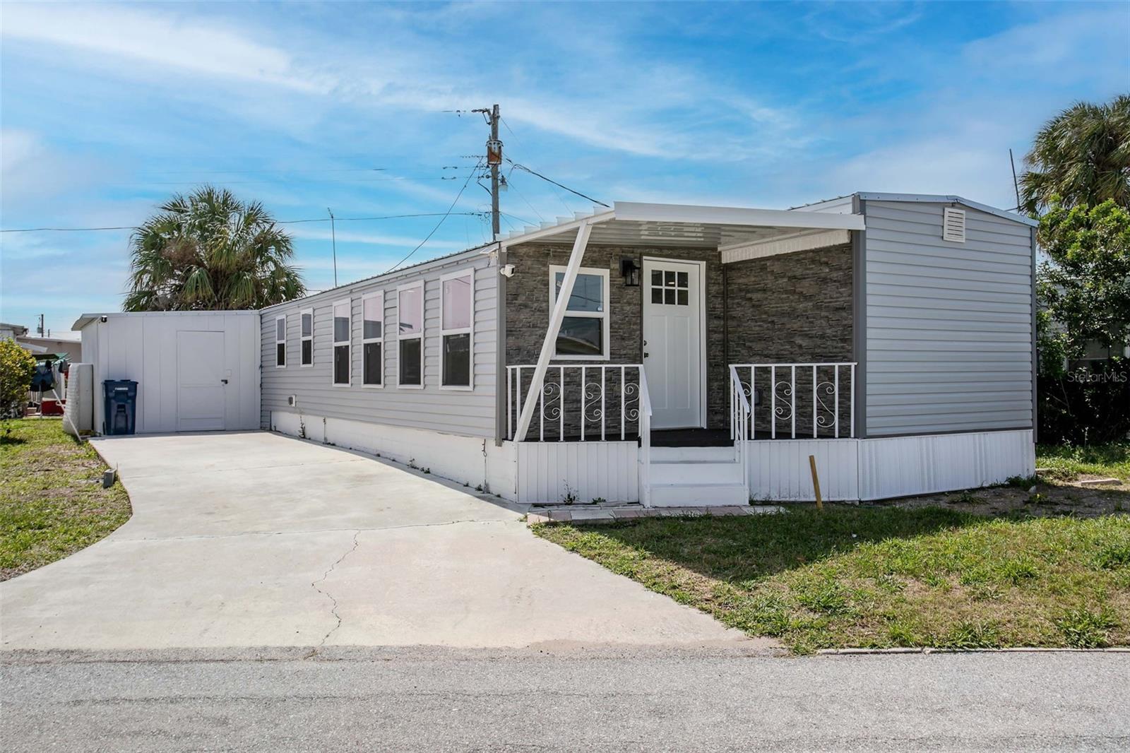 PRICE IMPROVEMENT. Completely updated interior and exterior.  New Metal Roof, Siding, Windows, Flooring, Cabinets, ect... and NOT due of hurricane damage.
 
Welcome to this beautifully updated mobile home offering modern style and versatile living! This home features a spacious bonus room alongside a 1-bedroom, 2 full bathroom layout, offering the perfect space for a home office, guest area, or additional living space.
The exterior showcases attractive brand new gray vinyl siding with charming brick accents on the covered front porch, creating great curb appeal. Inside, you’ll find luxury vinyl flooring throughout, complemented by updated can lighting that provides a bright and inviting atmosphere.
The kitchen has been thoughtfully upgraded with granite countertops, soft-close cabinetry, and an upcoming marble backsplash that will add an elegant finishing touch. Both full bathrooms have been well-appointed for comfort and convenience.
Major updates include a new metal roof and new windows throughout, offering peace of mind and energy efficiency. Step out back to enjoy the extended porch ideal for relaxing or entertaining. The home is also equipped with Ring doorbell security for added safety.
Conveniently located near beautiful Gulf beaches, shopping, and the airport, this home offers the perfect blend of comfort, style, and accessibility. Move-in ready with quality upgrades throughout.