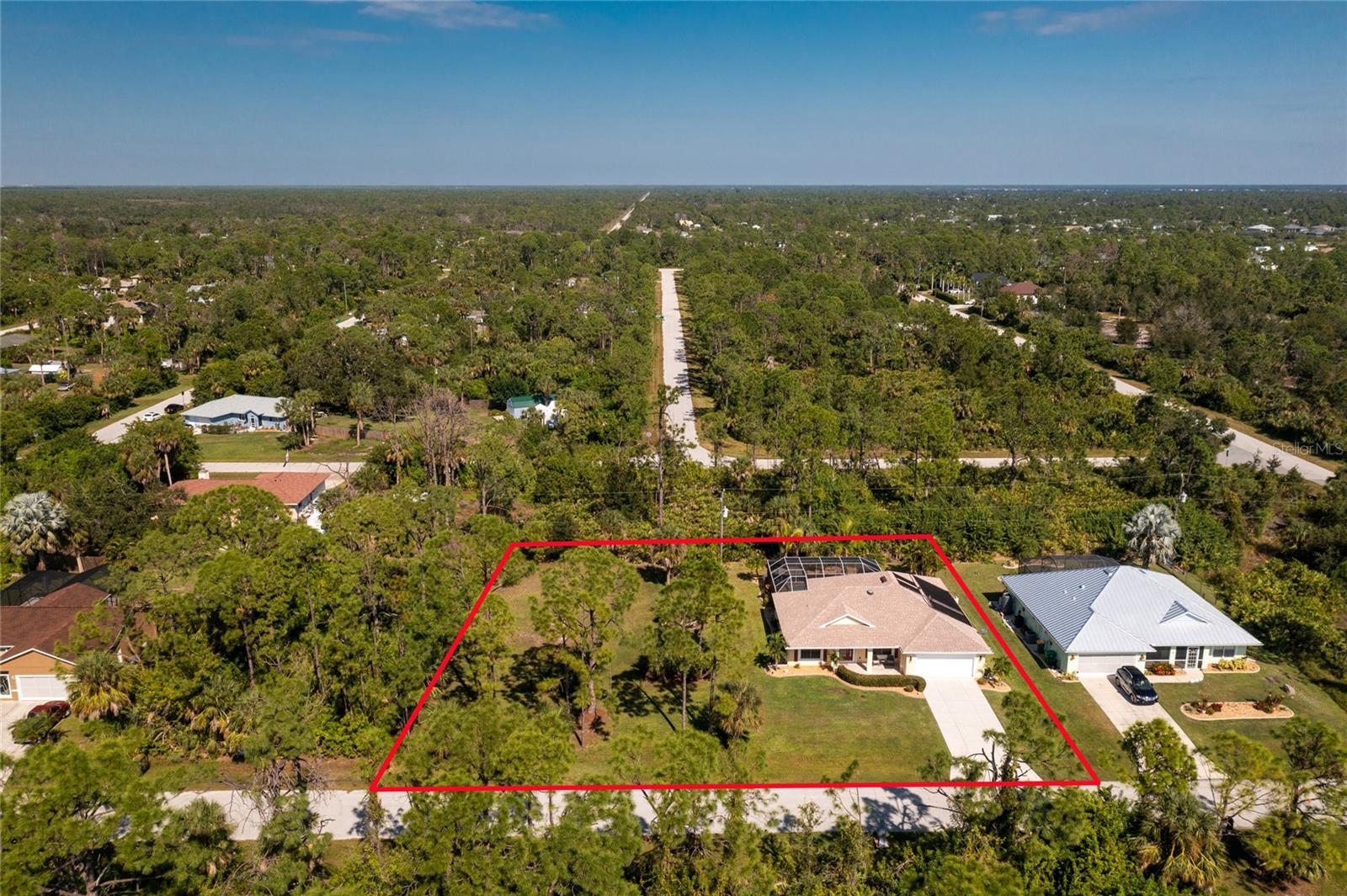 YOUR ABSOLUTELY STUNNING FULLY FURNISHED "FLORIDA DREAM HOME" AWAITS YOU ON A DOUBLE LOT (1/2 ACRE) WITH A BEAUTIFUL VIEW OF MAJESTIC TREES, CREATING A PEACEFUL AND PRIVATE OASIS. The well appointed home features a new roof, three bedrooms, two bathrooms, and an oversized patio with a screened in saltwater heated pool where you can take in the beautiful Florida lifestyle. As you walk into the home you will be greeted by a well designed open concept that is light and bright with vaulted ceilings that flows effortlessly from the formal dining room, living space, eat in kitchen and through the sliders to a beautiful pool and lanai area.  The split floor plan creates ultimate privacy for you and your guests or family members to have their own quiet retreat. The spacious owners suite with lanai access includes and en-suite bath featuring granite vanity, a newly designed shower, double sinks and expansive closet space. The kitchen boasts granite counter tops a large pantry and stainless steel appliances. The home features various upgrades, a NEW ROOF 2023 with new Gutters and Facia, RO SYSTEM 2022, Pool Pump 2022,  Salt System 2023, Septic System 2021, Skylight in the Living Area 2021, Master Bedroom Shower 2020 and carpet in 2023. The home is also hurricane protected with all impact windows and accordian hurricane shutters in the lanai to protect your outside furnishings. The DOUBLE LOT is beautifully appointed with impeccable landscaping. The lot can be used for a second garage, a second home, RV storage, guest cottage the possibilities are endless. In addition to the Double Lot the Lot across the street (MLS#D6133240) is also available for $20K. You could have 3 lots, a beautiful home with a heated pool and all the privacy and opportunity you would want for under $500K.  SERENITY AWAITS! DON'T MISS THIS OPPORTUNITY, THIS HOME WON'T LAST LONG! *List of Furnishings are available on the MLS*