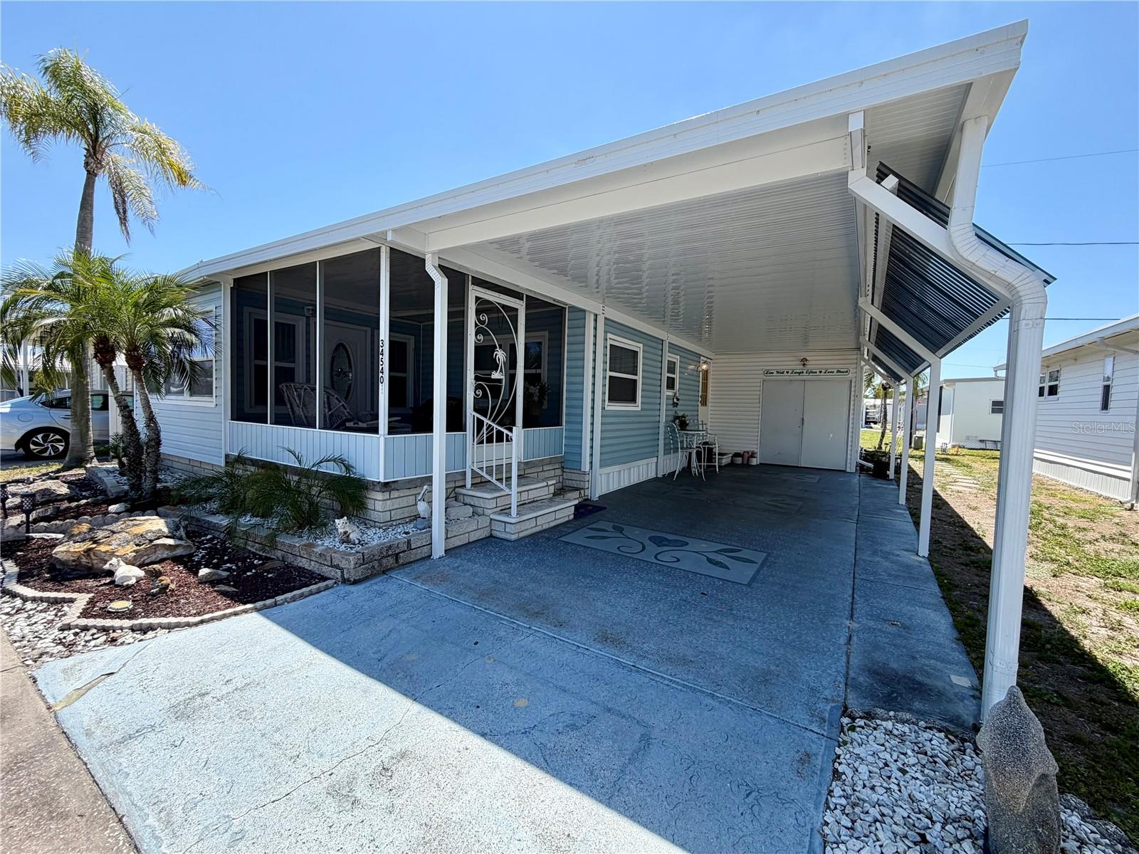 2BR/2BA double-wide in a top-5 rated Retirement Communities for 2025! Price includes Share, valued at $55,000… Lovely, open concept kitchen with stainless steel appliances, an oversized island, with ample amount of cabinetry … Newer vinyl flooring, double pane windows, roof-over (which includes the shed/laundry area), oversized shed which houses the stackable washer & dryer, the newer water heater, a wash tub AND has direct access to the interior of the home thru the 2nd bedroom.. A/C 2012. The bonus room (not included in square footage) offers flexible space and can serve as a third bedroom, closing off with barn doors for privacy. Both updated bathrooms include walk-in showers. Enjoy the cozy screened front porch! You can invite the whole family for relaxing and taking in the Florida lifestyle here……….
Sunset Palms is a 55+ Community and is 1 of Pinellas County‘s best kept secret in my opinion, very inexpensive living at only $210 per month which includes p; ****water/sewer/trash***, owned clubhouse, escrows are fully funded, beautiful heated pool and spa, fitness center, library, shuffleboard, billiard table, and a small lake at the back of the park, laundry room, and your very own private entrance to the super Walmart… on foot, bicycle or golf cart… Etc., etc. This location is close to churches, shopping, restaurants, approx 20-30 minutes to the beach or Tampa Int’l Airport. Jump on I-275 to Tampa, Sarasota, etc.