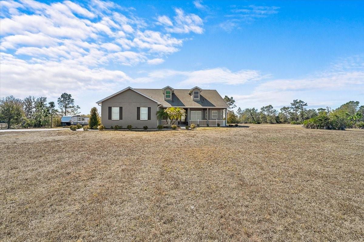 New and Improved Price! LIVE OFF THE LAND! Grow your own vegetables, bring your animals, and embrace the peaceful rhythm of country living — all while being just 15 minutes from shopping and dining.

This impeccably maintained 3-bedroom, 3-bath residence offers a thoughtful and versatile layout, including a dedicated office and an expansive bonus room currently used as a game room. The bonus space presents an excellent opportunity for a private in-law suite, with a full bath conveniently nearby. Two additional bedrooms with walk-in closets and a shared bath are tucked away in their own wing of the home, offering privacy and comfort.

The spacious primary suite easily accommodates a king-size bed with additional furnishings and a sitting area. The luxurious primary bath features separate his-and-her vanities, a private water closet, a garden tub, and a Roman walk-in shower.

Designed with impressive volume and natural light, the great room and kitchen boast soaring 12-foot ceilings, while the remaining rooms feature 10-foot ceilings throughout. The kitchen offers abundant cabinetry, a large double-door pantry, a formal dining room, and additional casual dining space.

The oversized laundry room is exceptionally functional, complete with a built-in vanity and sink, extensive cabinetry, folding counter space, hanging area, and built-in hampers. The 2.5-car garage includes 9-foot built-in storage closets, and a 50-amp generator connector adds convenience and peace of mind.

The salt water pool is long enough to actually swim laps. Enjoy entertaining under two spacious covered seating areas.

Outdoors, you’ll find a 12x30 workshop/shed equipped with water and electricity, beautiful pine tongue-and-groove porch ceilings, and a stunning pool area with two expansive covered spaces ideal for outdoor dining and lounging. The Roof is 5 Years Young. The Paved Driveway stretches approximately 300 feet, creating a grand and private entrance.

There is ample space to build a barn, stables, or even a large custom garage for automotive enthusiasts. Located approximately 5 miles from the Bradenton Motorsports Park. 
Bring the whole family and experience this exceptional property for yourself.

Washer and dryer do not convey.