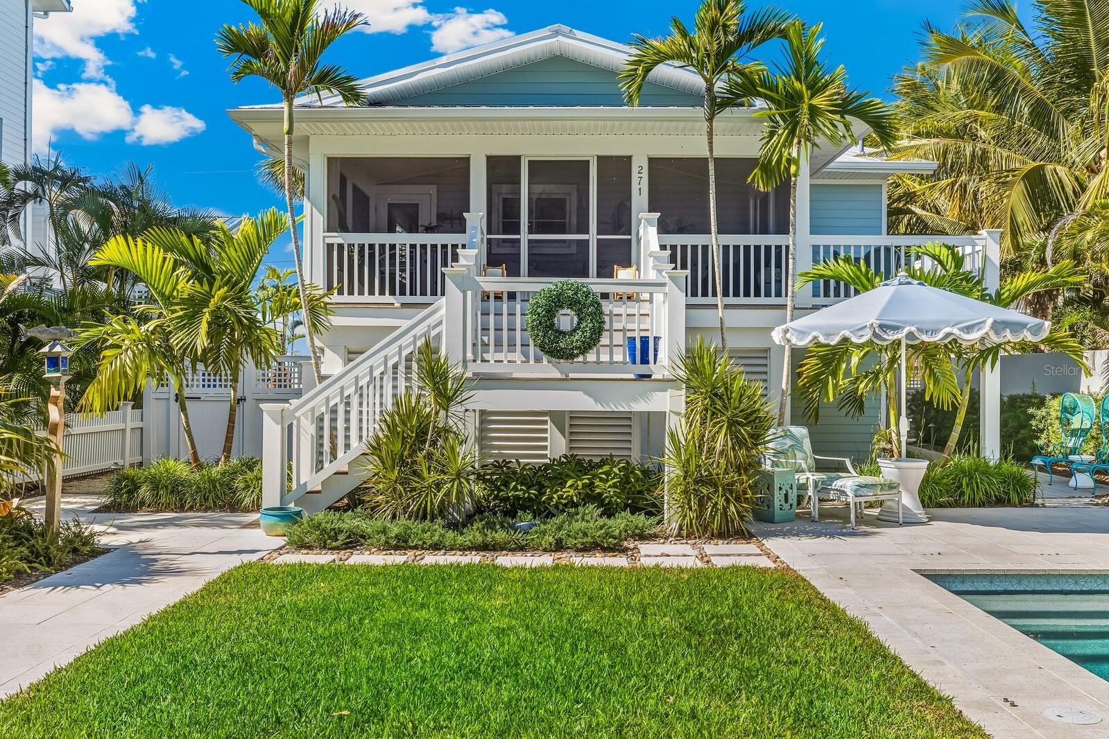 Embrace the laid-back elegance of island life in this beautifully updated 3 bedroom, 2.5 bath cottage, ideally situated just one row from the beach in Boca Grande’s historic village. Sunlight fills the home, highlighting timeless details such as crown molding, plantation shutters, and beautiful hardwood floors that flow through the main living areas. The kitchen is both stylish and functional, featuring KitchenAid appliances, solid wood soft-close cabinetry, quartz countertops, and a farmhouse sink. The primary suite serves as a serene retreat with a full ensuite bath offering dual sinks, granite countertops, custom cabinetry, and a frameless glass shower.
Downstairs, new tile flooring enhances the spacious ground level, which includes a secondary living area, two guest bedrooms, and a beautifully finished full bath with a glass-enclosed shower, perfect for hosting family and friends. Step outside to a screened lanai overlooking the heated pool, surrounded by mature landscaping and a fully fenced yard for privacy. Paver pathways lead to a generous golf cart garage, large enough for both parking and storage. There is also a private outdoor shower, perfect after a day at the beach. Recent updates include a new pool pump, pool heater, washer, and dryer. The home also features durable HardiePlank siding, a standing seam metal roof, and low-maintenance Apex decking for added peace of mind and longevity. Located on historic Whiskey Row with convenient off-street parking, this cottage perfectly blends privacy, convenience, and the quintessential Boca Grande lifestyle - timeless, relaxed, and effortlessly refined.