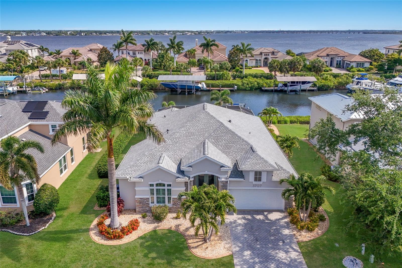 Experience the Florida waterfront lifestyle in this beautiful COMPLETELY UPDATED home on a WIDE SALTWATER CANAL in the River Pointe boating community, offering DIRECT Gulf access with no fixed bridges, no locke system, and the ability to have personal watercraft such as jet-skis - unlike the freshwater canal homes. This side of the street is the COVETED WIDE-CANAL SIDE that also does NOT have homes across the canal for epic PRIVACY. Located on a quiet dead-end street, the property provides both privacy and peace of mind, along with a PRIVATE DOCK AND 9k BOAT LIFT—perfect for boating, fishing, paddleboarding, and enjoying the water. The home was FULLY REMODELED, giving it a fresh, modern feel throughout. Every room was thoughtfully redesigned with updated finishes, clean lines, and a cohesive style. The kitchen features custom cabinetry, quartzite countertops, a SUB ZERO REFRIGERATOR, a 36-inch WOLF GAS STOVE, and a large island that works well for both everyday use and entertaining. The primary suite offers direct access to the lanai and includes a well-appointed bathroom with marble finishes, quality fixtures, and ample closet space. IMPACT WINDOWS AND DOORS throughout the home bring in plenty of natural light while also providing durability and energy efficiency. FULL HOUSE GENERATOR gives peace of mind during any power outages. Outside, the lanai is set up for relaxing and gathering, with a REFINISHED SPOOL (2022), an OUTDOOR KITCHEN with a built-in gas grill and side burner (2022), and plenty of space to sit and dine. Additional updates include epoxy-coated garage floors, a WHOLE HOUSE GENERATOR (2021), a NEW A/C (2021), a NEW ROOF (2024), a NEW POOL CAGE (2021), and a NEW GARAGE DOOR (2021). Conveniently located near I-75, the home offers easy access to Sarasota, St. Petersburg, and Tampa airports, as well as nearby beaches, dining, shopping, and more. This MOVE-IN READY home combines a complete interior renovation with a great waterfront location, making it ideal for enjoying the best of Florida living.