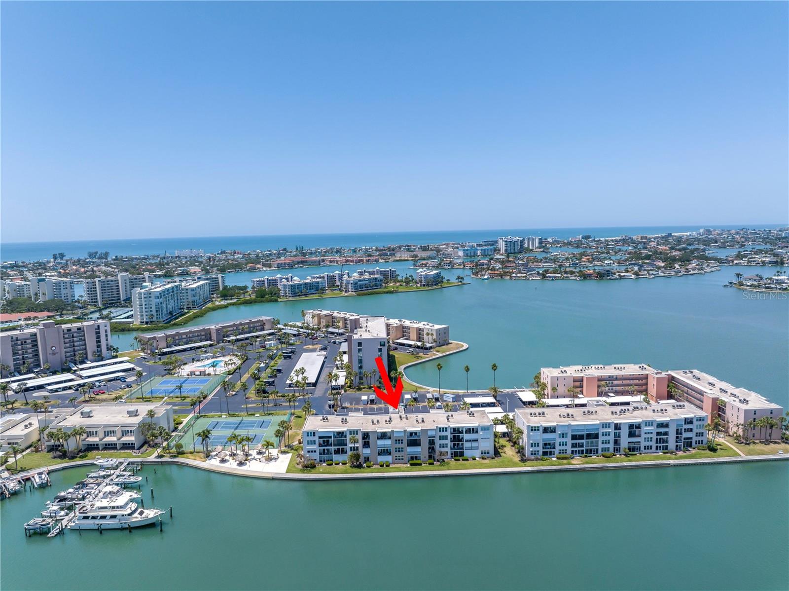 Welcome to the beautiful community of Bay Island. Located in the Heritage Building is directly on the water. RENOVATIONS completed April 2026! This first floor unit has an open floorplan with living, dining and kitchen with tiled backsplash and under cabinet lighting. The bathroom has a walk-in shower with white subway tile. The bedroom has a walk-in closet and BRAND NEW HURRICANE RATED sliding door that opens to a screen enclosed covered porch overlooking the water! Flooring, kitchen finishes, appliances and bathroom finishes are all NEW and covered by the community under their flood insurance coverage. This 24-hr guard gated waterfront community has an exceptional array of activities for the active resident including multiple pools & spas, tennis & pickleball courts, community room with activities such as yoga, entertainment and socials, shuffleboard courts, fitness center with sauna, waterfront tiki huts with grilling area and community marina for fishing or boating opportunities. The indoor amenities are in process of remediation and photos are pre storm for reference. Bay Island is a 55+ community. Ask for more details on this exceptional value condo. 2026 HOA fee is LOWER @ $539.89/month
