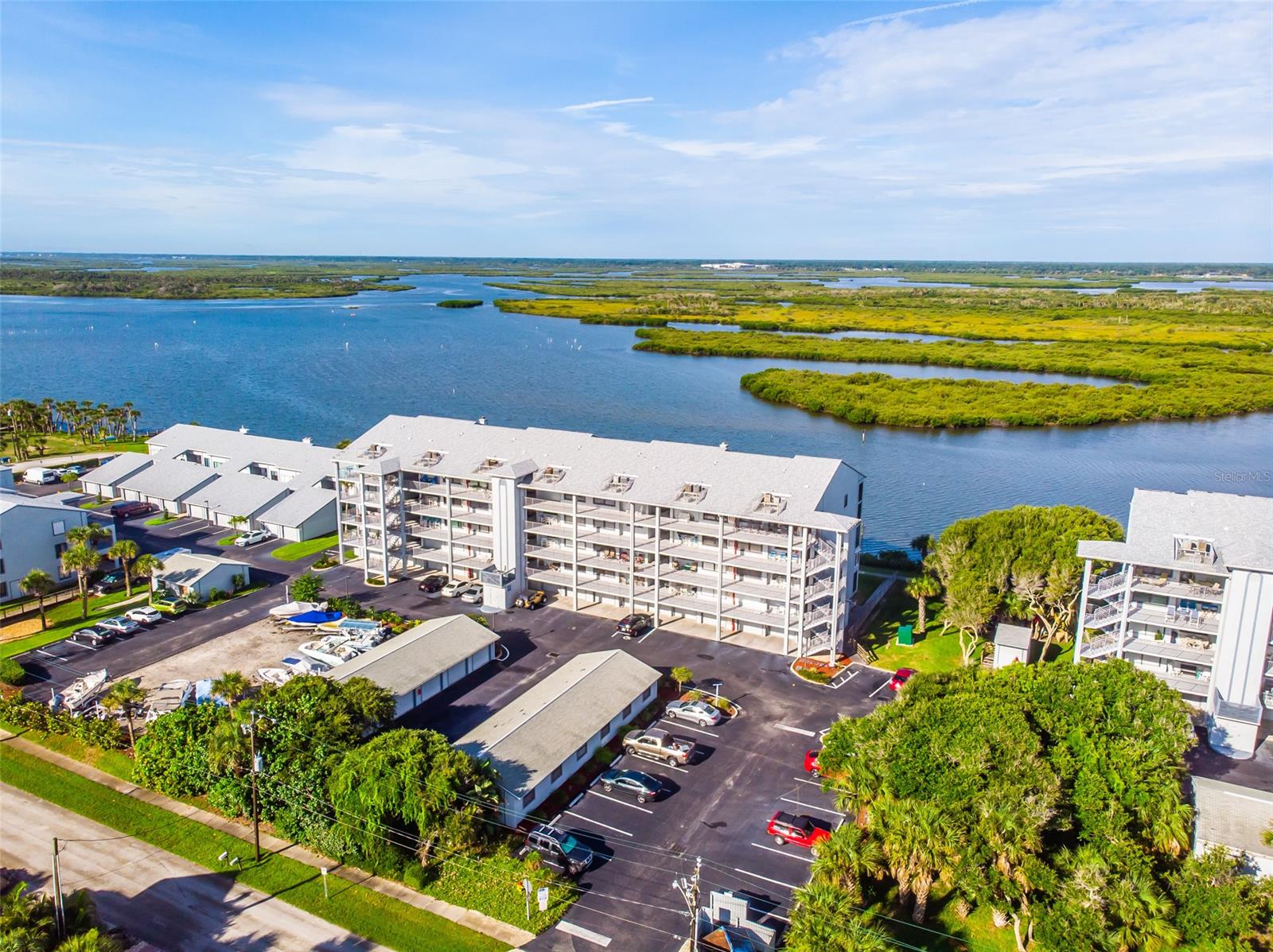 Great spacious Riverfront Condo! Located in the desirable Cedar Island Club complex, this 2 bedroom, 2 bath condo is a dream come true for avid fishermen and water enthusiasts. Fully furnished, this condo has new kitchen cabinets, granite counter tops, and new Kenmore appliances. No need to worry about replacing costly sliders! This condo has new impact glass sliders and electric hurricane shutters. The master bathroom and guest bathroom have both been updated. This condo is move-in ready with a murphy bed in the guest bedroom, washer and dryer in the unit and a huge screened in porch. Private 1 car garage. Boat and trailer storage on a first-come-first-serve basis. If you are looking for the perfect on the river getaway this is the place. Come enjoy the spectacular sunsets! ;Water: City