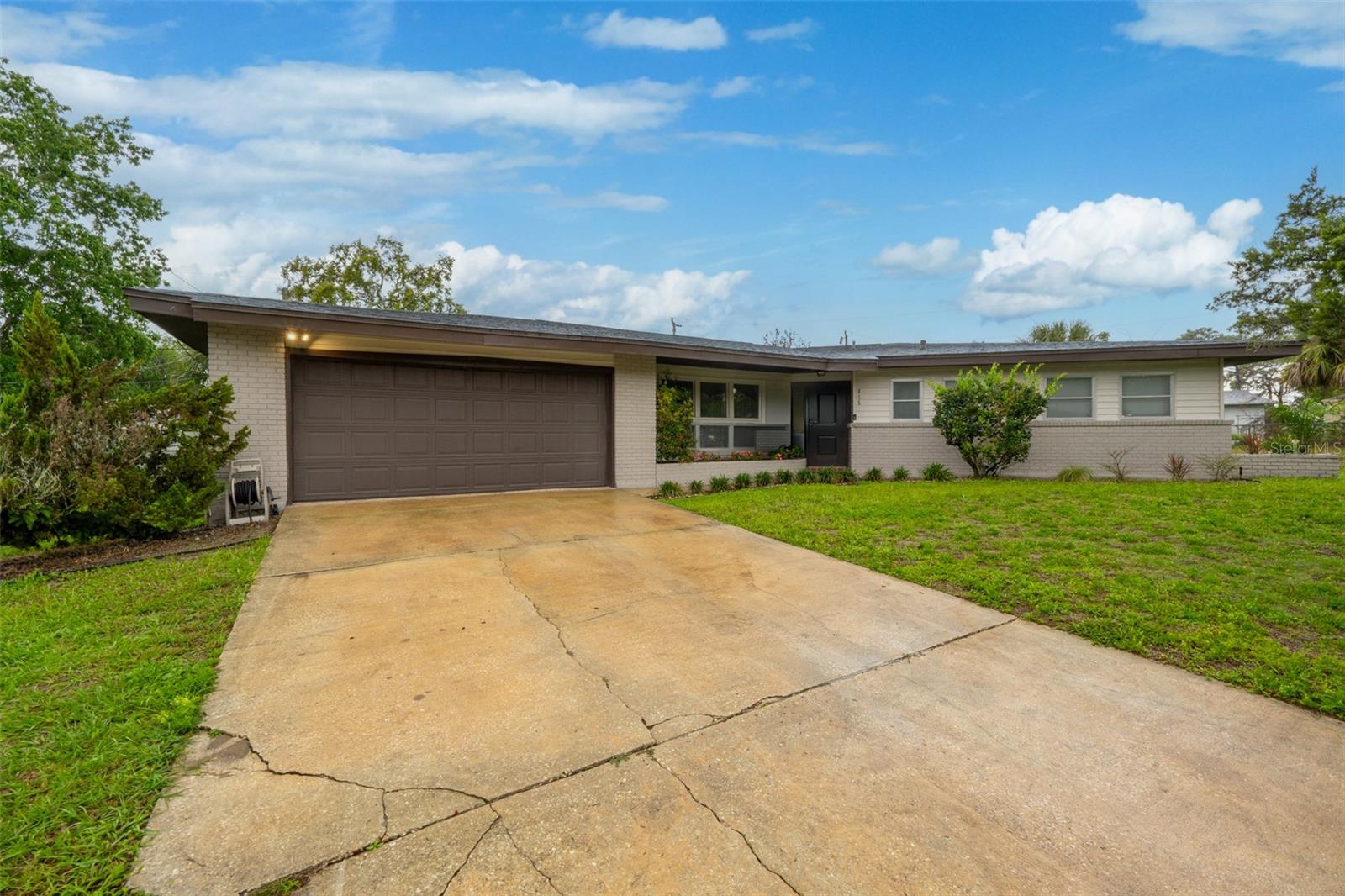 Live the Space Coast lifestyle in this beautifully updated 3-bed, 2.5-bath home. The 2022 remodeled kitchen shines with stainless appliances, granite countertops, and a large pantry. All bathrooms feature modern fixtures and fresh tile. Striking original terrazzo floors add a mid-century modern touch, wood laminate flows throughout the main living areas, and plush carpet adds comfort to every bedroom. The primary offers dual closets and a private en suite bath. The living room showcases a brick wood-burning fireplace and high ceilings. A 2022 roof, 2023 AC, and oversized 2-car garage complete the package, while the spacious lot delivers a serene backyard with mature landscaping, a storage shed, and a patio made for entertaining. Centrally located in Titusville minutes from shopping, dining, and front-row rocket launch views. 15 minutes from Kennedy Space Center, Cape and Port Canaveral are within 30, and Orlando's attractions are less than an hour's drive. Schedule your showing today!