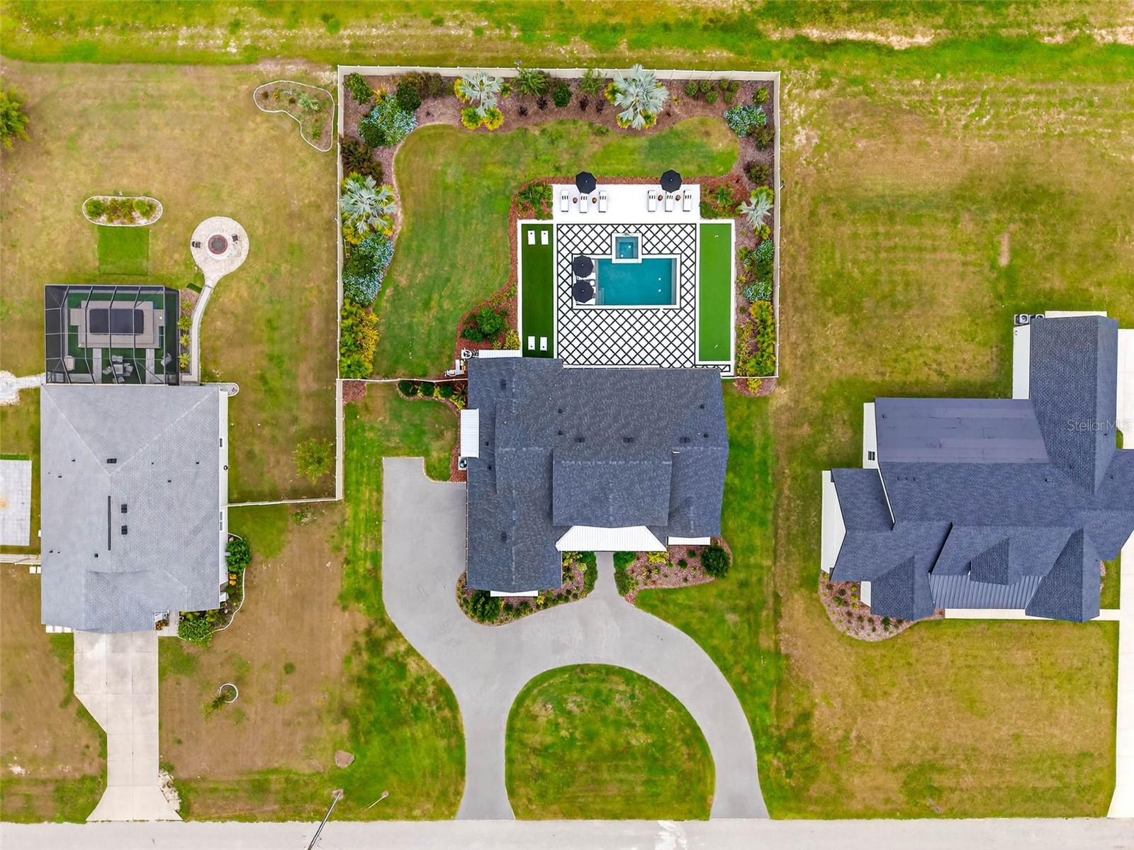 Welcome to your dream home! Featured in Florida Design Magazine, this stunning 4-bedroom, 3.5-bath modern farmhouse blends classic charm with modern luxury finishes throughout, including high end Arteriors and Hinkley lighting features, Emtek Cabinetry hardware and Brizo  plumbing features. Step inside to 10 foot ceilings, wide-plank hardwood floors, and an open-concept layout that’s perfect for entertaining. The gourmet kitchen features quartz countertops, stainless steel appliances and a beautiful waterfall island.The plantation shutters and large windows flood the family room/entertainment area with natural light. Custom draperies and high end wallpaper have elevated this home to the next level. French doors open to the professionally landscaped back yard and pool area where you can enjoy serene evenings cooking in the outdoor kitchen on the covered back porch. Retreat to the primary suite with a spa-inspired bathroom, double vanities, soaking tub, and oversized walk-in closet. Three additional bedrooms offer plenty of space and comfort. This property provides flexibility for a home office with the den/office located off the family room. It is conveniently located near top schools, shopping, and dining—you won’t want to miss it! Schedule your private tour today.