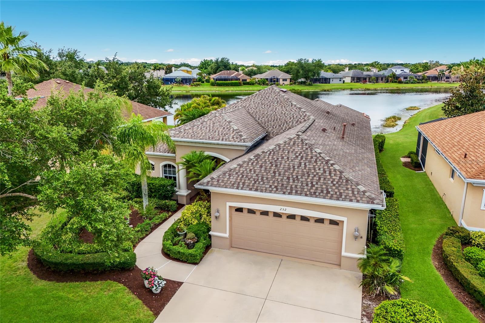 Located along a quiet cul-de-sac street in the gated community of GreyHawk Landing, this 4-bedroom, 3-bath pool home offers 2,214 square feet of living space, expansive pond views, desirable southwest exposure, and several important recent improvements. The property enjoys added breathing room provided by the adjacent easement area. Built by Homes by Towne, this home welcomes you with soaring ceilings, abundant natural light, and a thoughtfully designed floor plan featuring architectural details such as coffered and tray ceilings. A standout feature of the home is the disappearing corner sliding glass doors, which create a seamless connection between the indoor and outdoor living areas while framing the stunning water views beyond. The kitchen is centrally located within the home and features stainless steel appliances, including a refrigerator replaced in 2025, dishwasher and microwave in 2024, and range in 2021, along with a breakfast bar and plenty of cabinetry. The adjacent living and dining spaces make the home ideal for both everyday living and entertaining. The spacious primary suite offers tranquil pond views and direct access to the outdoor living area, while three additional bedrooms and two full guest baths provide flexibility for family, guests, or a home office. Step outside to enjoy Florida living at its finest. The screened lanai features an extended deck area, a pool with solar heating, privacy landscaping, and breathtaking water views. With desirable southwest exposure, the outdoor living space enjoys abundant afternoon sun and beautiful sunset reflections across the expansive pond. Whether enjoying your morning coffee, entertaining friends, or simply watching the ever-changing wildlife, the backyard serves as a peaceful retreat and true extension of the home. Recent improvements provide added peace of mind, including a new roof (2020), HVAC system (2025), gas water heater (2025), solar pool heating system (2020), and exterior paint (2021).  Additional features include hurricane shutters, an extended-width driveway, laundry room with plumbing for a future utility sink, and in-wall pest control. Beyond the home itself, GreyHawk Landing offers an exceptional lifestyle surrounded by more than 480 acres of preserved natural landscape. Known for its majestic oak trees, mature landscaping, and picturesque canopy-lined streets, this gated community provides a welcoming setting that feels established, peaceful, and connected to nature. Residents enjoy an impressive collection of amenities, including two clubhouses, a fitness center, two resort-style heated pools, including one with a splash and play area, lighted tennis/pickleball courts, a basketball court, athletic fields, a fishing pier, and trails for walking and biking. Zoned for top-rated schools and ideally located with convenient access to I-75, Lakewood Ranch, University Town Center, shopping, dining, and the Gulf Coast's award-winning beaches, GreyHawk Landing continues to be one of East Manatee County's most desirable communities.