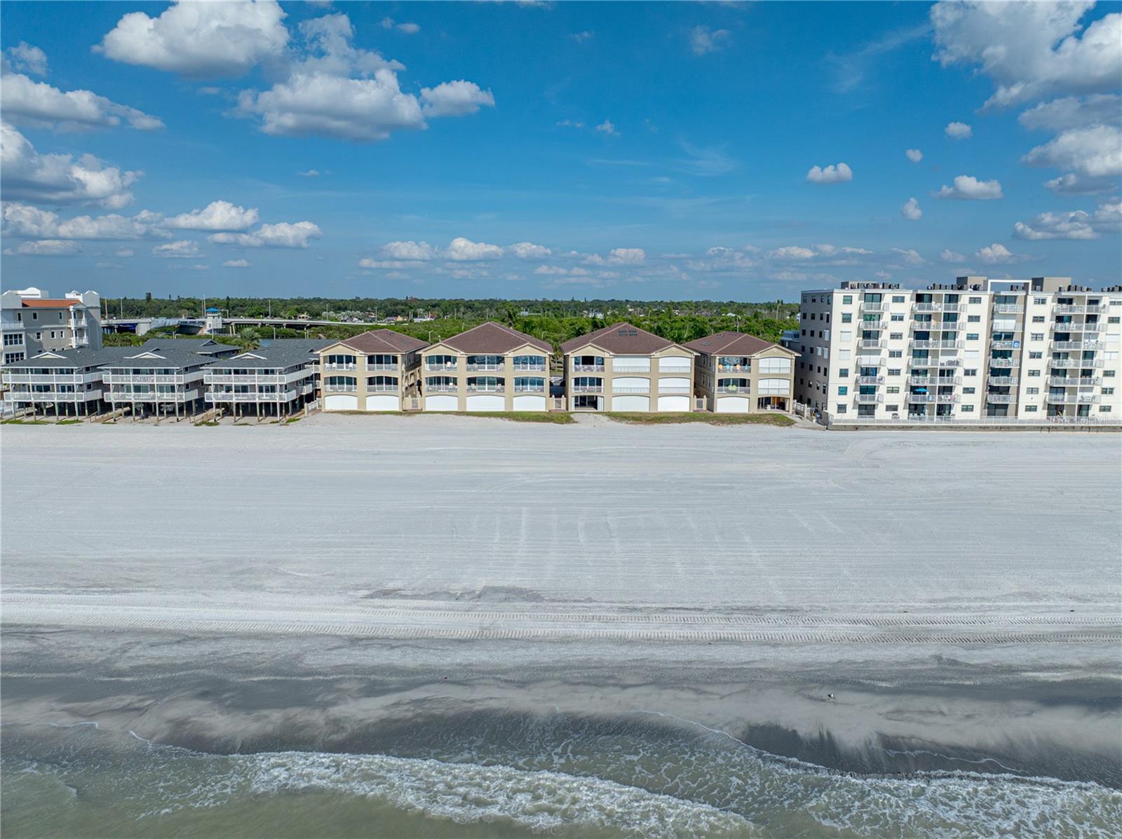 Rare Opportunity!  Welcome to Bella Playa, a well-managed ten-home Planned Unit Development directly on the Gulf in Indian Shores.  These are not condominiums; you own the land and the sand.  Unit 5 is an exceptional end-unit townhouse, offering the perfect combination of luxury, comfort, and convenience right on the Gulf Coast. This appealing home features high ceilings and an array of high-end upgrades and premium finishes, making it a true standout in today’s market. Catch every sunset and the occasional dolphin from the west-facing balconies. Having the beach at your back door demands durable LVP flooring throughout, ensuring easy maintenance and lasting beauty. The home is wired for sound, bringing music and entertainment to every room. Brand new (2025), durable tile roof, along with new impact-rated French doors and sliding doors featuring “Turtle Glass” and Low-E coatings for enhanced energy efficiency and weather protection. HVAC equipped with an ultraviolet light system for cleaner, fresher air throughout the home. The private elevator saves your knees and your back. Each spacious bedroom has its own en-suite bath. Elegant tray ceilings in the bedrooms add a touch of sophistication, and due to the end-unit advantage, an abundance of natural light creates an airy, open feel in every room. There's a laundry area tucked away on the same, second floor with the primary bedroom and bathroom for added convenience.  Built in fire suppression sprinklers are tested annually. The large, private, secure 3+ car garage has space for multiple vehicles and storage. Out the back door beckons a freshly-renourished, tranquil beach, providing a serene environment for beach walks, sunbathing, and water activities.
Bella Playa has a geothermal heated pool & hot tub, just steps from your door. Enjoy peace of mind with a gated entry and underground utilities, ensuring safety and minimal disruptions. Landscaping is currently undergoing a complete refresh.  The HOA Fee takes care of: water; sewer; trash; common area and pool maintenance and common area electricity.  The home is located at the intersection of Park and Gulf Blvds, making it convenient to local restaurants, shops and entertainment, like John's Pass (10 min) and Seminole City Center (7 min).  It's a 30 minute drive to St Pete/Clearwater airport and 35-45 minutes to Tampa International.
With limited turnover in this sought-after community, an opportunity like this one doesn’t come around often. Don’t miss your chance to own a piece of paradise—schedule a showing today and experience this incredible beachside home!