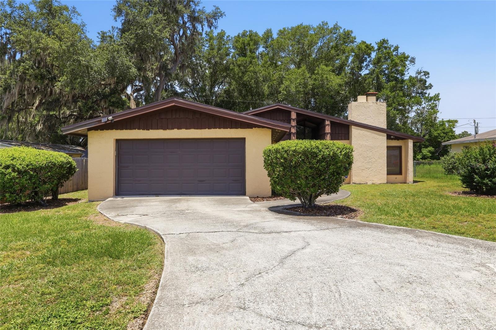 They simply don't make them like this anymore! Built with character, generous living spaces, and the kind of lot size that's becoming harder and harder to find, this home offers a rare opportunity to enjoy classic Florida living without the restrictions of newer developments. Step in the backyard and fall in love with the HUGE swimming pool, creating the perfect backyard oasis for relaxing, entertaining, and making memories all year long. The detached storage building is a fantastic bonus, providing plenty of room for pool equipment, lawn tools, and outdoor gear, helping keep your spacious two-car garage free for vehicles. Inside, you'll appreciate the warm and inviting living area highlighted by a large wood-burning fireplace, perfect for cozy evenings and holiday gatherings. The kitchen offers abundant storage, including a generous pantry that makes organization effortless and keeps everything within reach. A plant window above the kitchen sink so you can look at the big ol’ pool while you’re doing dishes or cooking diner. With three nicely sized bedrooms, two baths, plus a dedicated home office, providing the flexibility today's homeowners need for remote work, hobbies, a playroom, or even a potential guest space. Situated in a wonderful location, this home offers the freedom homeowners are looking for with no pesky HOA restrictions and no costly CDD fees. Whether you're enjoying the backyard paradise, gathering around the fireplace, or appreciating the extra storage and practical features throughout, this home delivers the lifestyle you've been searching for. NEW ROOF installed and WATER HEATER in 2022