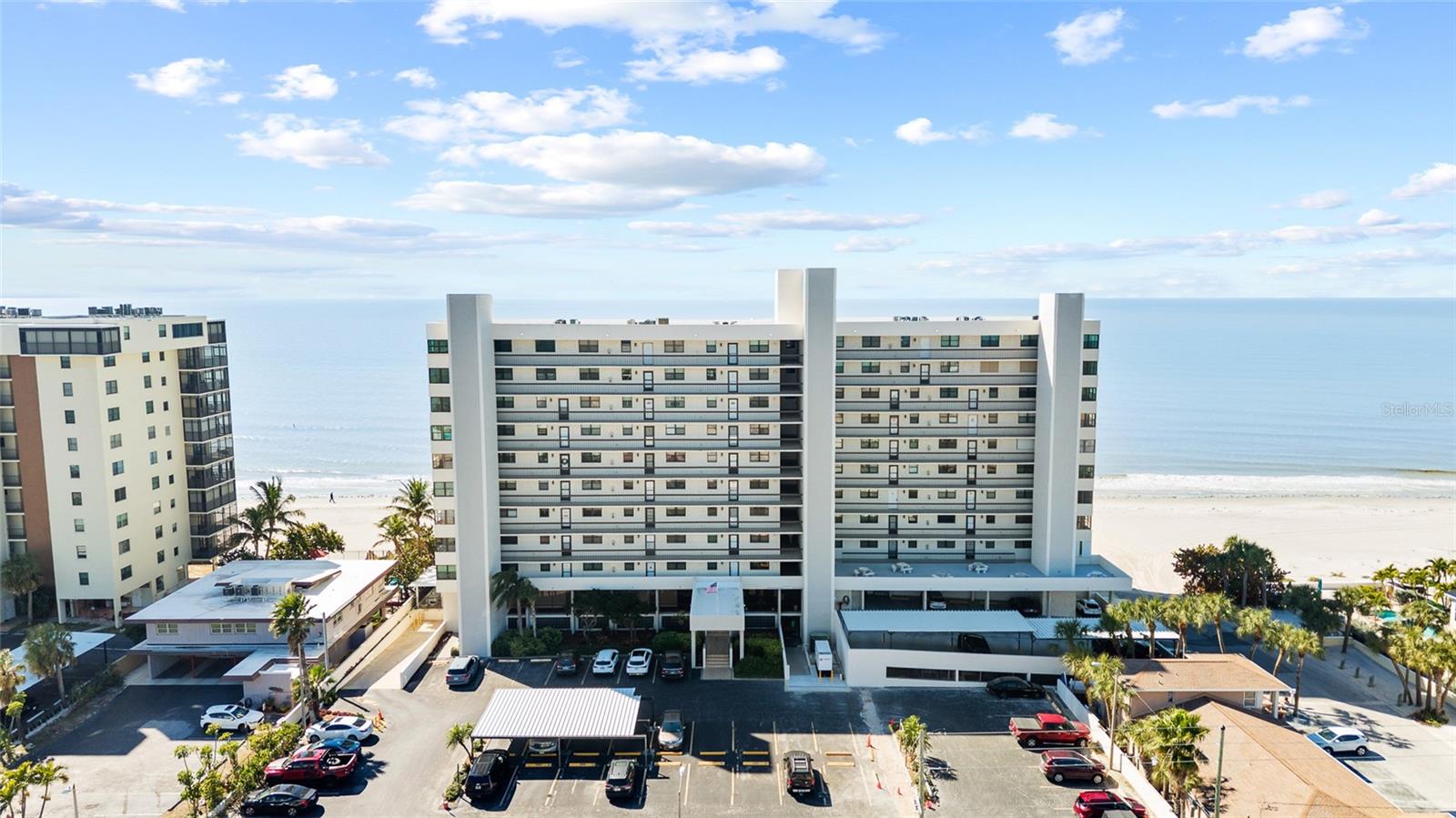 Wake up to endless Gulf views in this beautifully updated 6th floor corner residence at Surfside Tower, perfectly positioned at the end of the building for added privacy and sweeping panoramas of the beach, pool, and Intracoastal Waterway. This 2-bedroom, 2-bath condo is offered tastefully furnished and blends coastal elegance with modern upgrades throughout. The light-filled living room and primary suite both open Gulfside, creating a seamless connection to the balcony and breathtaking sunsets. The kitchen is a standout feature with a lighted domed ceiling, French Provincial cabinetry, granite countertops extended over the front-load washer and dryer for added workspace, and a cheerful breakfast nook overlooking the Intracoastal. Large bedrooms include walk-in closets and en-suite baths, while crown molding and electric hurricane shutters add comfort and style. Recent 2025 upgrades include luxury vinyl plank flooring in the living room, dining room, and bedrooms, new ceiling fans and light fixtures, updated baseboards, and fresh interior paint and texture. The secondary bedroom features plantation shutters and a spa-like en-suite bath with a massaging shower system. A portion of the balcony is enclosed, offering a private extended living area ideal for relaxing year-round. Surfside Tower offers resort-style amenities including a heated pool and spa, fitness center, recreation room with full kitchen for private events, billiards and card room, outdoor second-floor gathering patio, and an inviting lobby sitting area. On-site live-in management provides excellent maintenance and security. The unit includes one covered parking space plus abundant guest parking. Basic cable and high-speed internet are included. Ideally located just minutes from shopping, dining, entertainment, and the attractions of Gulf Boulevard and John’s Pass, this is Gulf-front living at its finest.