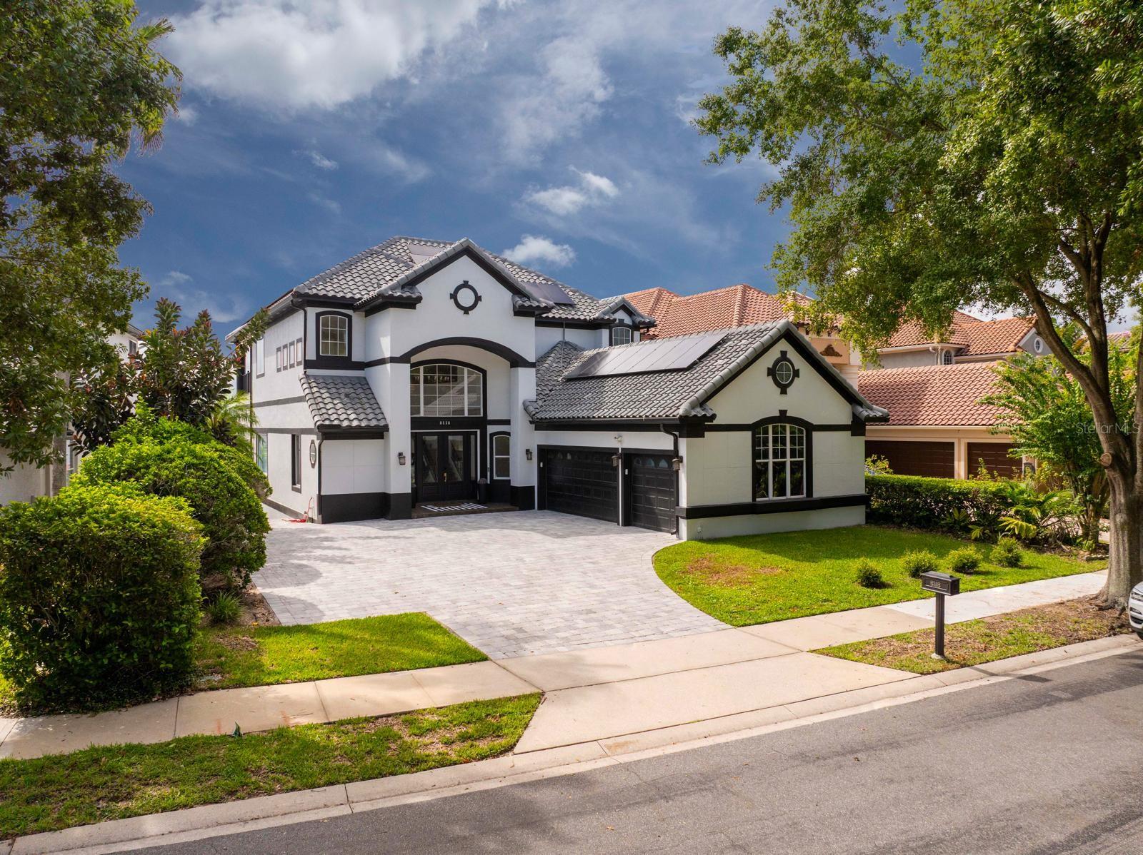One or more photo(s) has been virtually staged. Welcome to this exceptional 3-story lakefront estate, offering 6,244 sq. ft. of refined living space on a navigable lake with direct lake access. Recently completed top-to-bottom full renovation (June/24), over $650,000 in renovations, blends modern elegance, high-end finishes, and unparalleled functionality.

Property Highlights:
Fully renovated inside and out – including bathrooms, garage, and all major features, Freshly painted & sealed interior and exterior, including roof, Energy-efficient solar panels reducing power bills by up to 60. Custom cabinetry throughout, with floor-to-ceiling kitchen cabinets. High-end KitchenAid appliances. New paver driveway.
New AC Unit. 

Outdoor Living & Entertainment:
Direct access to the lake with expansive water views. Travertine decking and low-maintenance turf. Complete outdoor kitchen featuring:
Built-in grill, Outdoor refrigerator, Ice maker, Generous counter space for gatherings, New Pool Heater.
The pool was completely renovated 1 year ago, including a new finish and glass tile throughout the spa.
Enjoy SeaWorld’s nightly fireworks right from your backyard.

 Indoor Entertainment
Custom-built bar with full cabinetry. Dry wine cellar with 30+ bottle capacity. Separate refrigerators for beer,and wine.

Community Amenities (HOA)
Access to tennis courts. Fully equipped fitness center. Gated and Guarded community for privacy and security. 

Additional Features
Multiple designer wallpaper finishes throughout. Hurricane-impact windows for safety and peace of mind.
Negotiable modern furniture (less than 1 year old) You will also have the option to have the house partially furnished 

This home is truly turnkey—every detail thoughtfully designed for luxury, convenience, and comfort, with unmatched entertainment both indoors and outdoors.