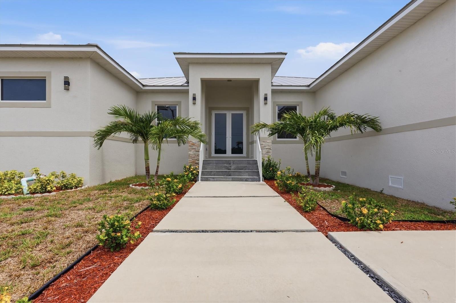 Welcome to a custom residence where timeless design, exceptional craftsmanship, and the effortless elegance of Florida living come together in perfect harmony.

Nestled within the coveted waterfront community of South Gulf Cove, this newly completed four-bedroom, four-bath luxury home offers over 2,400 square feet of impeccably designed living space, complemented by nearly 1,700 square feet of covered outdoor living that transforms everyday moments into unforgettable experiences.

From the moment you step inside, you're greeted by soaring ceilings, walls of natural light, and an open-concept floor plan that feels both grand and inviting. Every detail has been intentionally selected to create a home that is equally stunning for entertaining and wonderfully comfortable for everyday life.

At the heart of the home, the chef's kitchen is a true showpiece—where family naturally gathers and lasting memories begin. Rich solid wood cabinetry, premium stainless steel appliances, an impressive 10-foot waterfall quartz island, and expansive preparation space provide the perfect setting for everything from casual breakfasts to holiday celebrations. Whether you're preparing dinner while friends gather around the island or hosting generations of family under one roof, this space was designed to bring people together.

The owner's suite is a private sanctuary designed to restore and recharge. Bathed in natural light, it offers generous walk-in closets and a spa-inspired bath that rivals the finest luxury resorts. Indulge in the oversized dual-head walk-in shower, unwind in the elegant freestanding soaking tub, enjoy thoughtful details that transform everyday routines into moments of relaxation.

Beyond the sliding glass doors lies the true centerpiece of the home—an extraordinary outdoor living space designed for the Southwest Florida lifestyle. Wrapped in elegant nonslip tile, the expansive lanai becomes a natural extension of the interior, creating multiple spaces to gather, dine, celebrate, and unwind.

The spectacular 12-by-32-foot custom pool features an oversized swim bench, built-in umbrella sleeve, and panoramic screen enclosure that frames peaceful Florida skies without distracting from the view. Imagine laughing with family and friends as they spend afternoons floating beneath the sun, evenings sharing dinner around the outdoor table, and holidays filled with gatherings poolside long after the sun has set. This is more than a backyard—it is where memories are made and traditions begin.

Designed with equal attention to beauty and durability, the home features solid CBS construction, an elevated stem-wall foundation built above base flood elevation, impact-rated windows and doors, a standing-seam metal roof, irrigation system, and a two-car garage complete with electric vehicle charging capability—providing both luxury and lasting peace of mind.

Life in South Gulf Cove is about far more than the home itself. This sought-after waterfront community offers optional HOA membership, community parks, boat ramps, miles of sidewalks, and direct access to some of Southwest Florida's finest boating and fishing waters. Spend your mornings on the Gulf of Mexico, your afternoons relaxing on the sugar-sand beaches of Boca Grande, Englewood, and Manasota Key, and your evenings enjoying waterfront dining, championship golf, vibrant local events, and breathtaking sunsets.

Welcome home.
