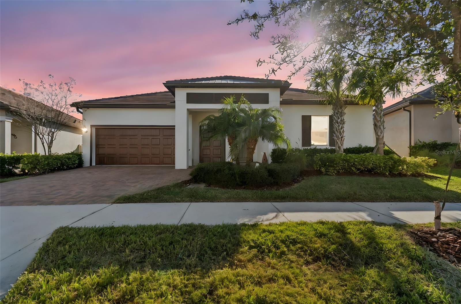 Experience true resort-style living in the highly sought-after 55+ active adult community of Medley at Mirada in San Antonio, Florida. Built in 2021, this move-in-ready 3-bedroom, 2.5-bath residence with a rare 3-car garage offers 2,350 square feet of thoughtfully designed living space, ideal for those seeking a vibrant, low-maintenance Florida lifestyle. Inside, the home features custom luxury vinyl plank flooring throughout. The open-concept design creates seamless flow between living, dining, and kitchen spaces. The kitchen is well-appointed with granite countertops, 42” cabinetry with crown molding, stainless steel appliances, an electric range, built-in microwave/oven combo, side-by-side refrigerator, and a spacious walk-in pantry, making it equally suited for daily living and entertaining. The luxury primary suite is a private retreat, showcasing an oversized curbless walk-in shower, dual vanities, private water closet, makeup counter/station, and an oversized walk-in closet. Two additional bedrooms offer flexibility for guests, a home office, or hobby space, while the convenient half bath is ideal for visitors. Outdoor living is a standout feature of this home. Enjoy a large covered lanai, perfect for grilling and relaxing, which opens to an extended paver patio with birdcage screen enclosure and hot tub. The fully enclosed vinyl-fenced backyard provides a level of privacy rarely found in active adult communities—ideal for peaceful mornings, entertaining, or pet-friendly living. Additional highlights include walk-up attic storage for seasonal organization and a 3-car garage offering ample room for vehicles, golf carts, and storage. Residents of Medley at Mirada enjoy an unmatched collection of resort-style amenities, including gated entry, luxury landscaping, and maintenance-free lawn and landscape care. Community features center around a private clubhouse with a restaurant and café/bar, state-of-the-art fitness center, heated resort-style pool, tennis, pickleball, bocce ball, and shuffleboard courts, billiards hall, ballroom, community rooms, fire pits, dog park and dog washing station, and a robust calendar of clubs, classes, and social events coordinated by a dedicated lifestyle team. A signature highlight of the community is exclusive access to the world-renowned 15-acre Mirada Crystal Lagoon, offering opportunities for swimming, kayaking, paddleboarding, and relaxing along sandy beaches—bringing a true vacation-inspired atmosphere home every day. The neighborhood also features walking and biking trails, golf cart-friendly streets, picnic areas, and scenic common spaces designed to support an active, connected lifestyle. Ultra-fast high-speed internet service is available community-wide, appealing to modern buyers and remote professionals. Conveniently located near everyday necessities, the home offers easy access to grocery stores, pharmacies, casual dining, healthcare services, and neighborhood conveniences, with expanded shopping, dining, and entertainment options nearby in San Antonio and Wesley Chapel, including major retail destinations. This exceptional property delivers the perfect blend of resort-style amenities, active adult living, privacy, and modern design within one of Pasco County’s most desirable 55+ communities.
