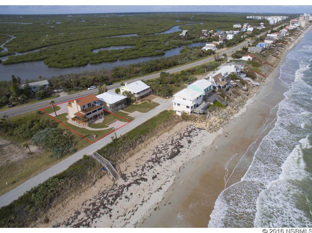 PRICE SLASHED FOR QUICK SALE! Ever notice how some homes exceed your expectations? Presented is one of the finest beach offerings to come in years, and on the NO DRIVE BEACH.   Prepare to wow your senses with endless luxury finishes, panoramic DIRECT OCEAN VIEWS, and some of the most tasteful coastal renovation techniques you will ever come across. This 3 Bedroom 3 Bath home boasts 3900 total SF (3420 under air) and includes a 2-car air-conditioned garage, plus plenty of paver parking for guests. Taking you through the home; The ground floor has a premium garage (epoxy floors, built-in cabs & workbench), full laundry and an in-law/guest apartment with covered porch and private entrance worthy of a magazine. The 2nd floor will take your breath away with brand new exterior covered ocean deck, custom driftwood finishes throughout interior, a remodeled chefâs kitchen, exotic granite, wood floors, gas fireplace, a guest bedroom, posh bath, 2nd laundry & more views.  The 3rd level is a dedicated master suite with larger sitting area, a multitude of closets, an opulent bath & an enormous ocean deck allowing spectacular views of the ocean (Unlike many neighbors to north & south, this home has no power lines obstructing the ocean view). This home is accessible to all floors via internal stairs. Too many upgrades to list; New and/or rebuilt storm shutters, structural fortification, new hardi board gables, stair lifts, new electric panel, outlets and switches, new plumbing in kitchens & baths, new interior lighting & fans, new paint, rebuilt gas fireplace & chimney, new decking on three levels with stainless cable & aluminum railings, 25-year  aluminum roofing, 2 new air conditioners in 2011, and rebuilt in 2016, new doors, numerous windows, duct work, R-30 blown insulation, fire/burglar alarm system, new paver driveway and walkways. A 50â easement to the south assures the utmost privacy. Wake up to sunrises over the breakers and end your day with sunsets over the lagoon. ;Water: City