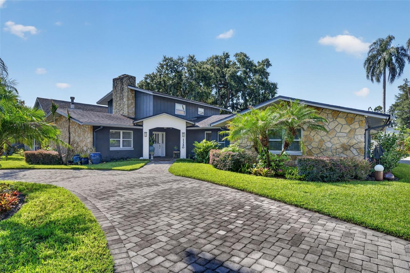 Under contract-accepting backup offers. Nestled on a rare 0.32-acre double lot in the desirable College Park neighborhood, this beautifully renovated home offers exceptional space, timeless style, and an unbeatable location, just a short walk to Bishop Moore High School and St. Charles Borromeo School. Completely renovated in 2014 and meticulously maintained, the home features a flexible floor plan with a desirable split layout. The first floor is designed for comfortable everyday living and easy entertaining, with a family room with a fireplace, a formal dining room, an updated kitchen, and a spacious rear living room with French doors opening to the covered patio and backyard. Well-equipped for everyday cooking, the kitchen features granite countertops, a center island with bar seating, double ovens, stainless-steel Whirlpool appliances, a farmhouse sink, and a walk-in pantry. The primary suite is downstairs and includes three closets, including a walk-in closet, an updated bath with dual vanities and a walk-in shower, and an adjoining flex room ideal for a nursery or office. A second downstairs bedroom has a custom closet and an attached full bath, while two additional bedrooms and another full bath are located upstairs. Hardwood floors run throughout much of the home, complemented by custom closet systems, abundant storage, an interior laundry closet, and quality finishes. The home was connected to city sewer in 2015, with additional recent improvements including interior paint. Outside, the covered patio overlooks a private backyard filled with mature landscaping and a greenhouse, offering plenty of space to relax, play, or entertain. A circular driveway, an extended side driveway, and a two-car carport provide ample parking for family and guests. Ideally located just minutes from Downtown College Park, Downtown Orlando, AdventHealth, Orlando Health, and I-4, this move-in-ready home combines an outstanding location with a rare oversized homesite and an exceptional floor plan.