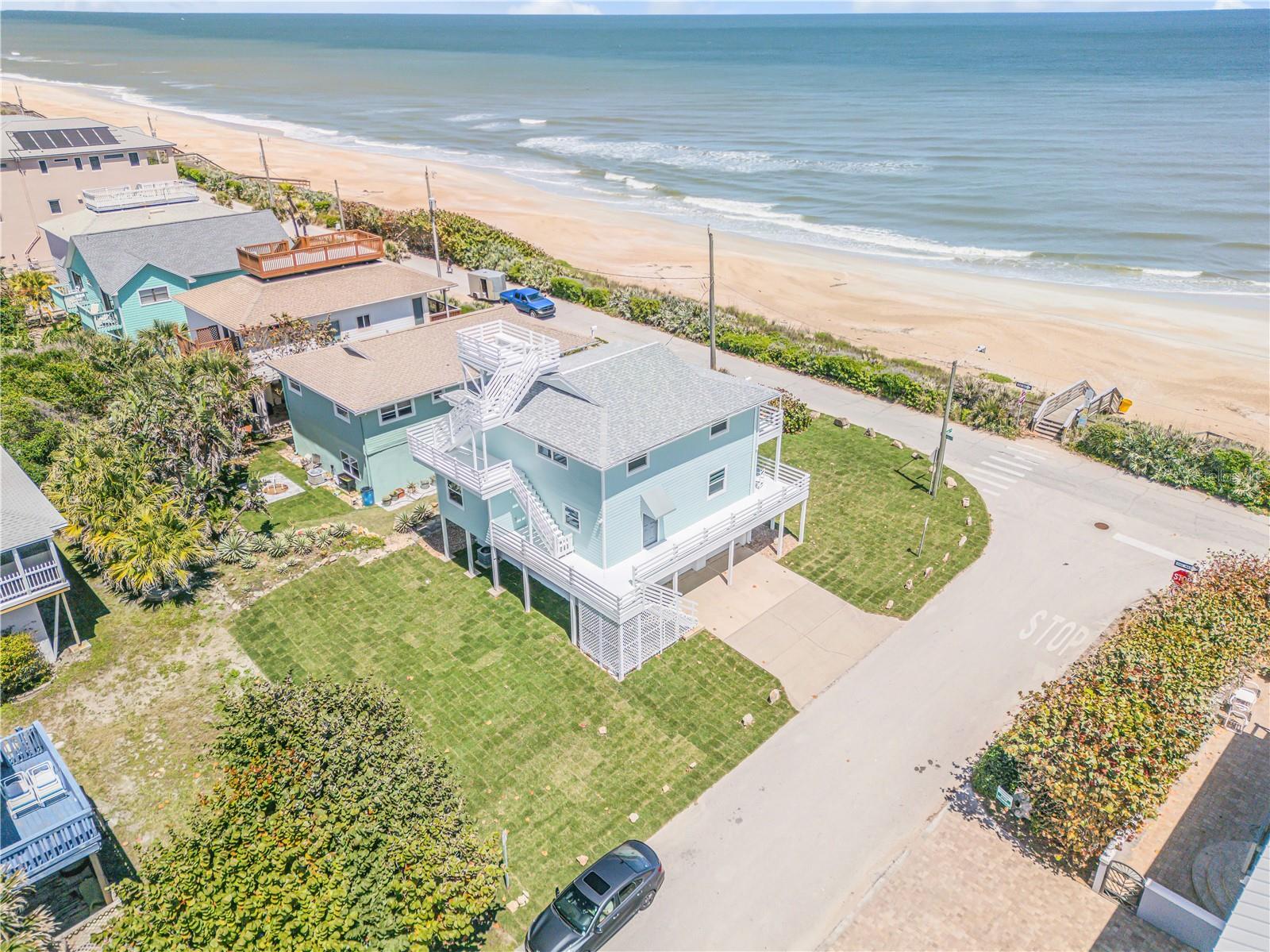 Experience true coastal living in this beautifully renovated direct oceanfront three-story home in New Smyrna Beach. This 3-bedroom, 2-bathroom residence has been completely transformed and offers stunning views and abundant natural light from nearly every room, creating a bright and inviting atmosphere throughout. Perfect as a primary residence or a second beach retreat, the home is ideally positioned to take full advantage of its breathtaking surroundings. Thoughtfully designed for convenience, laundry is located on both the first and third floors. Step outside to enjoy world-class flats fishing and convenient access to a nearby public boat ramp, while incredible sandbars just offshore provide excellent surfing right in front of your home. The expansive rooftop deck delivers unforgettable sunrise and sunset views, along with front-row seats to spectacular rocket launches. A massive garage offers endless space for storing all your fishing and beach gear. Just down the street, you can easily launch your boat into the pristine waters of Canaveral National Seashore, known as the longest stretch of undeveloped Atlantic coastline in Florida. This is a rare opportunity to own a truly special oceanfront property that must be seen in person to fully appreciate.