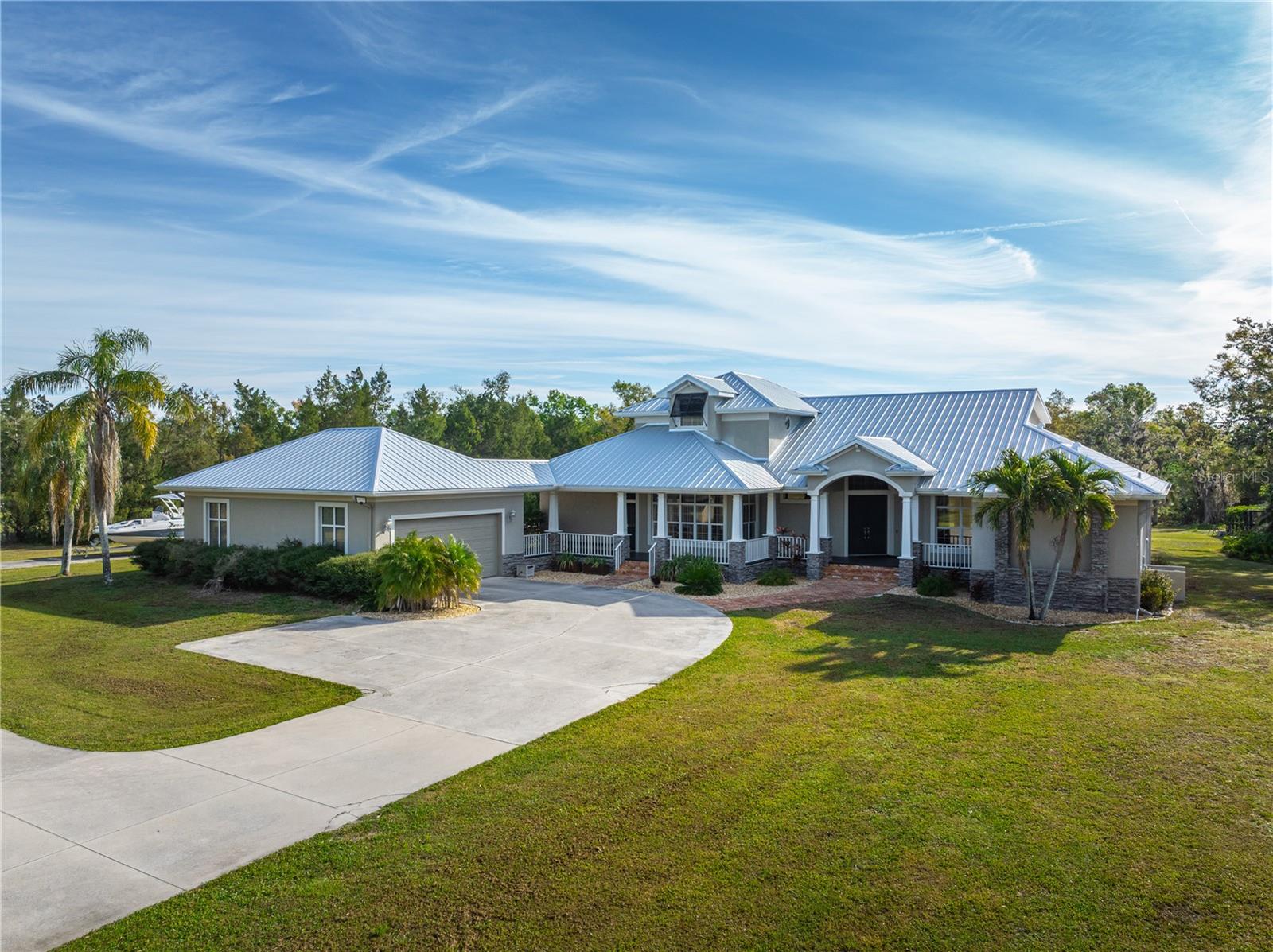 Private, Peaceful, and Serene perfectly describe this picturesque Key West-style home on 5.15
acres. A charming southern-style porch invites you to sit and relax. Inside, the spacious layout
features 4 bedrooms, 3.5 baths, and an upstairs flex room, offering plenty of living space.
The open-concept living, kitchen, and dining areas are bathed in natural light, with stunning
views of the front yard and backyard pool. Step outside to the expansive covered patio, where
you’ll find a self-cleaning saltwater pool with fountain (2021) and panoramic screened enclosure
(2022). A large covered seating area and pergola are perfect for entertaining or unwinding while
watching deer graze nearby.
The first-floor owner’s suite is a true retreat, featuring a spacious walk-in closet, built-in storage,
a claw-foot tub, and a walk-in shower. Upstairs, the three additional bedrooms provide unique features
like a window seat, built-in shelving, and an elevated desk space. The flex room can be used as a
fifth bedroom, media room, office, or den.
Outside, mature trees and a dry creek bed create a secluded, natural escape. A 31’ x 40’ block
outbuilding provides ample space for RV storage, a workshop, or even a future guest house. It
includes workbenches, a half bath, and a climate-controlled upstairs room—ideal for a home
gym or tack room for horses. The 12’ x 31’ paved lean-to at the back makes caring for animals
or storing equipment easy.
Recent upgrades make this home move-in ready, including a new metal roof (2024), new water
heater (2023), well pump (2023), Culligan water filtration system (2021), Rain Bird irrigation
system (2023), asphalt driveway (2023), and two AC units with MERV 13 & UV lights (2020).
Conveniently located just 10 minutes from I-75, University Town Center shopping, and dining,
and 15 minutes from Downtown Sarasota, this property offers the best of country living with city
conveniences nearby.
Optional: A Mahindra 2638 Tractor, Gator all-terrain vehicle with dump feature, John Deere zero-turn
mower and Toro Timecutter Mower are available for purchase separately or included for the right price.
Don’t miss this rare opportunity to own a peaceful retreat with modern upgrades in a prime
Sarasota location!