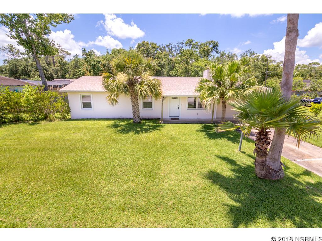Large Triple Lot, cozy 3 bedroom and 1 and a half bath home with a stone fireplace. This turn key, updated home has a new roof, double paned impact windows and slider, stainless steel appliances and tile and vinyl throughout.There is also a transferable termite bond. Out of the sliding door you have a screened lanai that overlooks the huge fenced in yard. There is plenty of room for a pool, RV, boat, all your toys and a carport with a double gated side entrance to make access easy. The concrete block workshop has a loft with a storage shed attached next to it for all you yard tools. Come bring your toys and make this you next home! ;Water: City