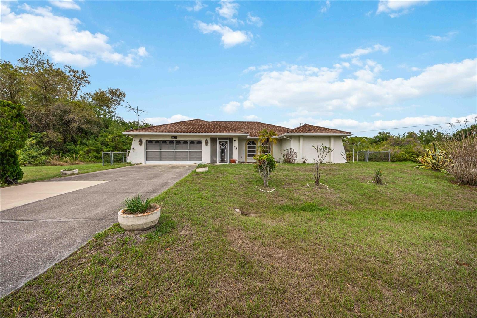 Situated on an oversized corner lot in a quiet North Port neighborhood, this 3-bedroom, 2-bathroom pool home offers great potential for the right buyer. The home features a spacious layout with tile and laminate flooring, a comfortable living area, and a functional kitchen with adjoining dining space. A split-bedroom floor plan provides added privacy, with a primary suite that includes its own bathroom and two additional bedrooms that can accommodate family, guests, or a home office. This property does need some TLC, including a thorough cleaning and fresh paint inside and out, but it presents a solid opportunity to make it your own. The private backyard includes a pool, offering a great space for relaxing or entertaining once refreshed. Major updates include a 2023 roof and 2024 HVAC system. Located in Flood Zone X with no HOA or CDD fees, this home provides added peace of mind and affordability. Conveniently situated near major roadways, shopping, dining, and area beaches. Schedule your showing today!