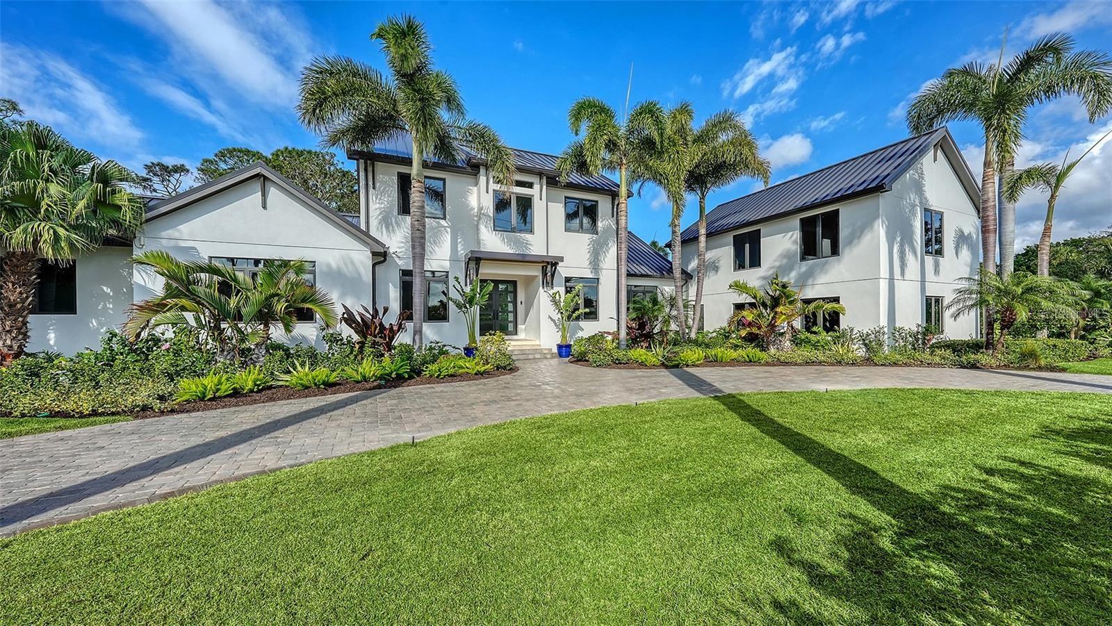 Virtually Staged. *PENDING - ACCEPTING BACKUPS*Virtually Staged. Nestled just south of the Ringling Museum, this prestigious West of Trail estate is set in Sarasota’s historic Indian Beach Sapphire Shores neighborhood, known for its majestic tree-canopied streets, bayfront parks, and architectural charm. Spanning 5,712 sq. ft. on a one-half acre lot, this home is designed for multi-generational living, featuring 5 bedrooms, 6.5 baths, 2 offices, and a private in-law suite. A newly built 616 sq. ft. detached guest house with a kitchenette and full bath offers additional flexibility. Extensively remodeled in 2013 and upgraded in 2023 by Murray Homes, the residence boasts a new roof, smart home features, low-voltage lighting, high-end cabinetry, new flooring, an updated kitchen, deck, and lush landscaping. The chef’s kitchen is a showpiece of design and functionality, highlighted by a raised skylight with exposed beam rafters over the 11’8” x 3’7” Cambria White Cliff quartz island with a waterfall mitered end panel and counter-height breakfast bar for five. Soft-close solid wood cabinetry includes pull-out shelves and recessed LED lighting. Top-tier appliances feature a Wolf double oven, Wolf 48” 6-burner gas range, Subzero column refrigerator/freezer, two dishwashers, and an instant hot/cold filtered water faucet. A café nook with a coffee bar and custom cabinetry adds convenience. Designed for seamless indoor-outdoor living, the spacious great room features engineered white oak plank flooring and a floor-to-ceiling walnut slat entertainment wall with a ventless fireplace. A striking agate-topped dry bar with a custom wine bottle display enhances the dining area. The brand-new screened lanai with French white oak Azek decking extends the living space outdoors. The 400 sq. ft. family room provides a flexible retreat, featuring a floating cabinetry entertainment wall, a full pool bath, additional laundry, hidden storage, and a private entrance from the pool deck. Outside, a 2,000 sq. ft. backyard retreat offers a 40 x 15 heated saltwater pool with a cascading waterfall, cooling lime rock pavers, pristine turf, and a brand-new outdoor kitchen with a gas grill and refrigerator. A motorized pergola adjusts for sun or shade, creating a luxurious resort-style setting. The fully fenced yard and lush landscaping enhance the privacy of this location. A brick-paver courtyard and circular driveway add elegance while offering ample parking and space to add an additional garage. This property is not in a flood zone. Minutes from downtown Sarasota, Lido Beach, and St. Armands Circle, the home is perfectly positioned near Ringling College of Art, New College, and the North Trail’s independent restaurants, coffee shops, and pubs.