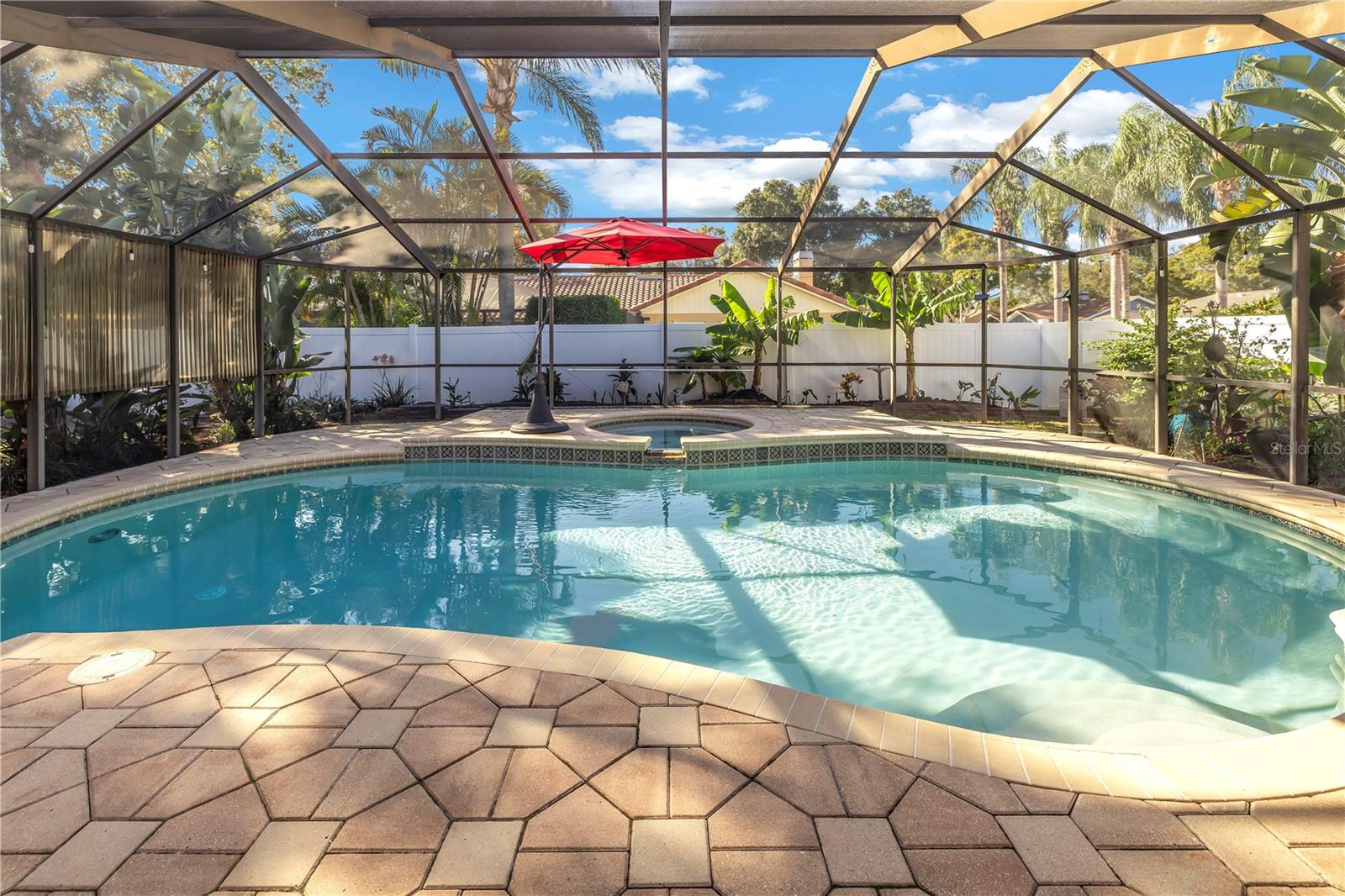 POOL PARADISE ON A CORNER LOT – WON’T LAST LONG !! This spacious split plan 4 bedroom, 2 bath, pool home has it all! The kitchen showcases gorgeous hardwood cabinetry, granite counter tops and New stainless steel appliances (all new 2022). Natural gas is available in this home for the following: range, water heater, laundry and fireplace. Enjoy the best that Florida has to offer with the expansive outdoor living area. The huge under-roof lanai showcases a vaulted screen enclosure and overlooks the resort style pool and spa. The pavered pool deck is large enough for all your patio furniture or grilling station needs. The large yard is fully enclosed with privacy fencing and includes a shed for additional storage. An additional pavered parking pad is ready for a boat, trailer or RV – BRING YOUR TOYS! Entertaining here is made easy with the open concept kitchen, large living room and additional family room both boasting a vaulted ceiling and upgraded light fixtures. If you are looking for a cozy place to have your morning coffee or a great spot for a firepit, look no further than the private open-air pavered patio located off of Bedroom #2. The spacious master bedroom has an en-suite bath, walk-in closet and sliding doors leading to the screened-in lanai. All bathrooms feature updated vanities with granite counter tops. Nothing has been missed in this home – New AC (2020) including ducts cleaned and resealed, New Water heater (2021), updated tile flooring throughout, pool was resurfaced (2012) and is heated by solar panels, lush landscape is easily maintained with the sprinkler/irrigation system, and home is fully equipped with a water softener. Plenty of storage here with the oversized 2 car garage, shed and tons of closets. The inside laundry room makes chores a breeze with the additional cabinetry and utility sink. Close to Shopping, Restaurants and just minutes from the Gulf Beaches. A quick closing is OK here. No HOA, no flood zone – SAVES YOU MONEY $$ !!