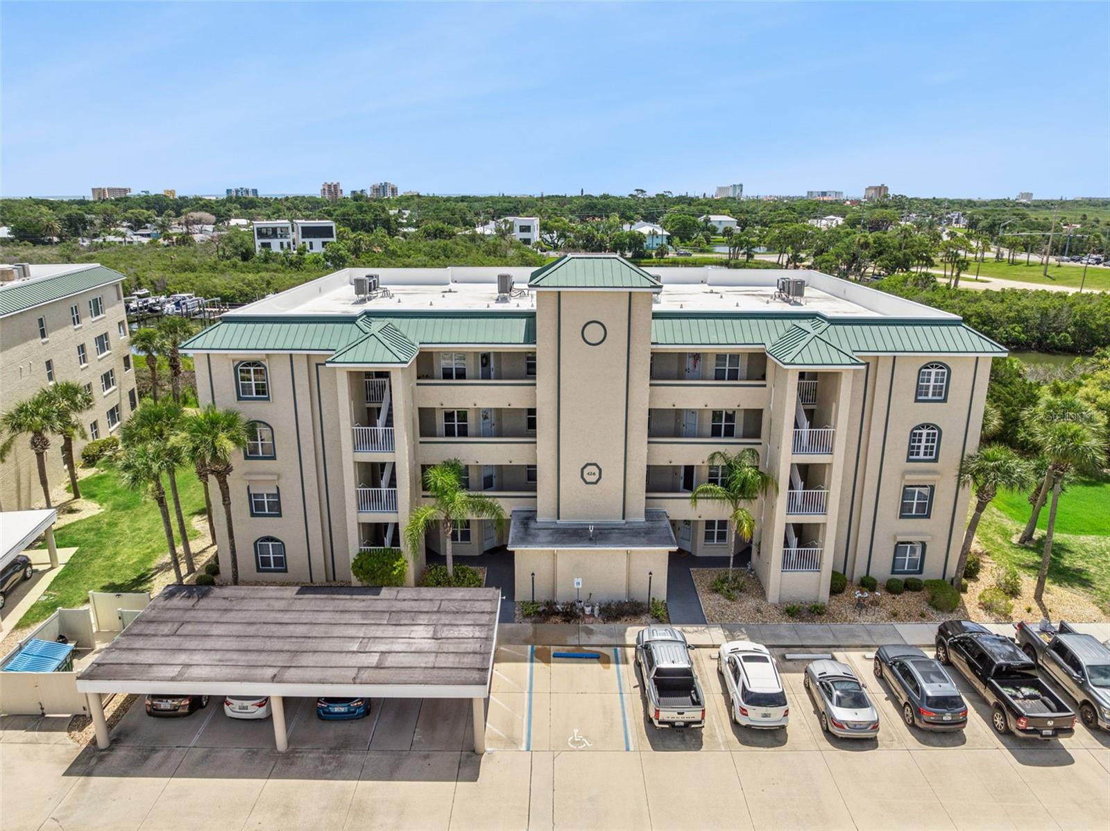 Experience coastal living at its finest in this fully furnished 3-bedroom, 3-bathroom first-floor condominium located in the highly desirable Bouchelle Island community of New Smyrna Beach. Step inside the spacious foyer and move seamlessly into the open-concept living and dining area, creating the perfect space for relaxing or entertaining. The adjoining kitchen features stone countertops, a breakfast bar, ample cabinet storage, and plenty of workspace for preparing your favorite meals.

The thoughtfully designed floor plan offers privacy and comfort for residents and guests alike. Tucked away at the rear of the condo, the spacious primary suite features a walk-in closet and a large en-suite bathroom. Near the front of the unit, you'll find two additional bedrooms, including one with its own private bathroom, while the third bathroom is conveniently accessible from the hallway.

Sliding glass doors from both the living area and primary bedroom open to a bright enclosed patio with large windows, providing the perfect spot to enjoy your morning coffee or unwind after a day at the beach.

Bouchelle Island offers an exceptional resort-style lifestyle with amenities, including an 18-hole pitch-and-putt golf course, tennis and pickleball courts, two heated swimming pools and spas, a fitness center, clubhouse with kitchen and gas grills.  Boating enthusiasts will appreciate the wet and dry boat slips and private boat ramp providing direct access to the Indian River. Residents can also enjoy riverfront tiki huts, fire pits, BBQ grills, and gathering spaces overlooking the water.

Ideally located just minutes from the vibrant shops, restaurants as well as easy access to New Smyrna Beach's beautiful shoreline, this exceptional property offers the Florida lifestyle you've been dreaming of.