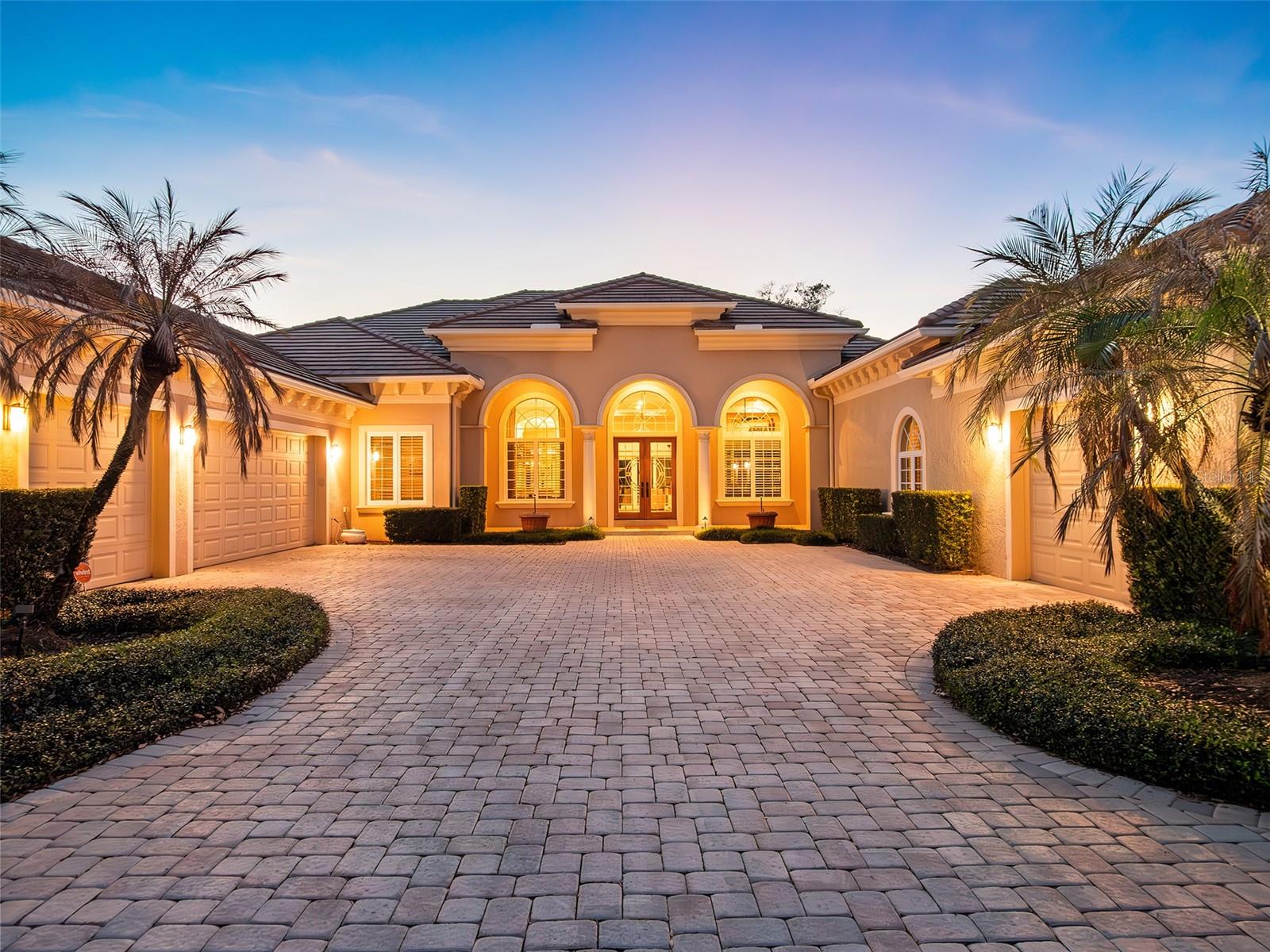 Positioned along the stunning 4th fairway of the renowned Isleworth Golf & Country Club, this exceptional single-story estate offers four bedrooms and more than 5,300 square feet of meticulously crafted living space. Every detail of this residence reflects the owner’s exceptional craftsmanship, with bespoke woodwork woven throughout the home, culminating in the crown jewel: the primary suite’s expansive wardrobe, featuring a central island, tiger wood floors, and cherry birch built-in displays—a true collector’s dream. The elegant foyer sets the tone, leading to formal living and dining spaces, and flowing effortlessly past a private office into the heart of the home: an open-concept kitchen, casual dining area, and family room designed for both entertaining and daily living. The gourmet kitchen is appointed with anigre wood cabinetry, a center island, dual sinks, a walk-in pantry, and professional appliances by Sub-Zero, Dacor, and Kitchenaid, marrying style and functionality in perfect harmony. A spacious game room with a wet bar provides an ideal space for recreation or hosting, while four luxurious bedrooms and 4.5 spa-inspired baths ensure comfort and privacy for family and guests alike. Seamlessly blending indoor and outdoor living, the estate features a sparkling open-air pool set against serene golf course vistas—an idyllic setting for year-round leisure and entertaining. Additional highlights include a circular driveway and motor court, a three-car garage, and a separate workshop. This is a rare opportunity to acquire a residence where world-class craftsmanship, refined design, and premier golf-front location converge, offering an unparalleled lifestyle in one of Central Florida’s most coveted enclaves.