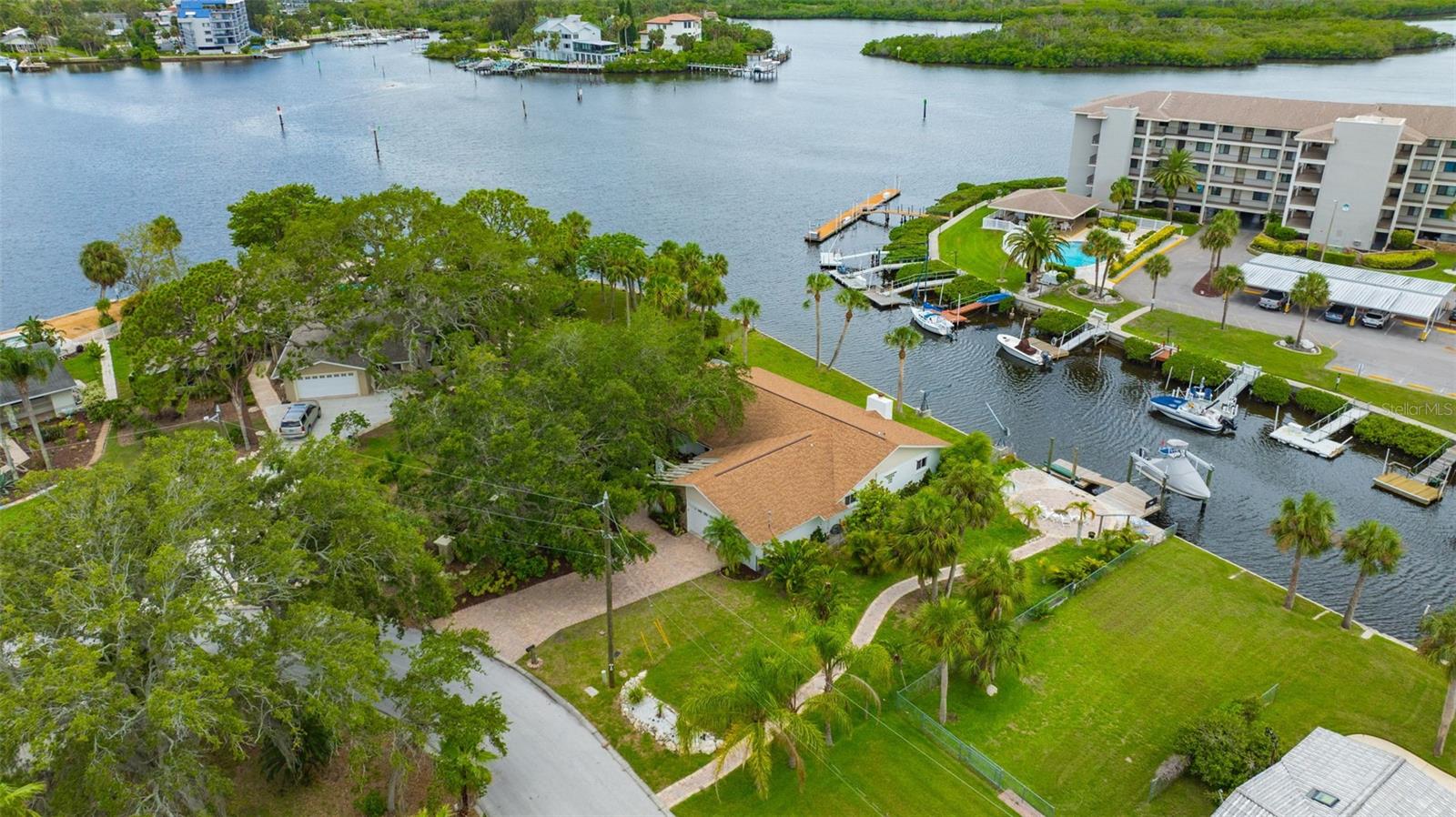 One or more photo(s) has been virtually staged. WELCOME TO PARADISE! This beautifully renovated waterfront home sits on a spacious lot with mature landscaping, offering both charm and privacy. Step inside to an open living/dining room combo where stunning water views immediately steal the show. The upgraded kitchen is a true standout, perfect for everyday living and entertainment. Featuring quartz countertops, wood cabinetry, modern backsplash, and new stainless-steel appliances. Unwind in the cozy family room complete with wood burning fireplace. Enjoy the seamless flow of coastal inspired, wood look tile flooring throughout the living areas and all three bedrooms - stylish, modern, and easy to maintain. The primary suite is your private retreat, featuring French doors that open to serene waterfront views. The ensuite bathroom offers a deep soaking jacuzzi tub, separate shower, and double vanity. Both bathrooms have been updated with brand new vanities and granite countertops. One of the home's many standout features is the oversized indoor laundry room, rare and incredibly convenient. Step outside and discover a backyard that truly sets this property apart. The fully fenced yard boasts an impressive 120 feet of waterfront seawall and exceptional privacy with no direct neighbors on either side. Relax and enjoy breathtaking sunsets, ocean breezes, and even dolphin sightings from the screened in back porch, complete with spa hookup. With direct Gulf access, this home is a dream for boating and water enthusiasts alike. Conveniently located in the heart of Port Richey, you're minutes away from shopping, dining, and entertainment - by land or sea! Additional updates include a newer roof (February 2020) and new AC unit (January 2025), making this home truly move in ready. Don't miss your chance to own this waterfront gem. Schedule your private showing today!
