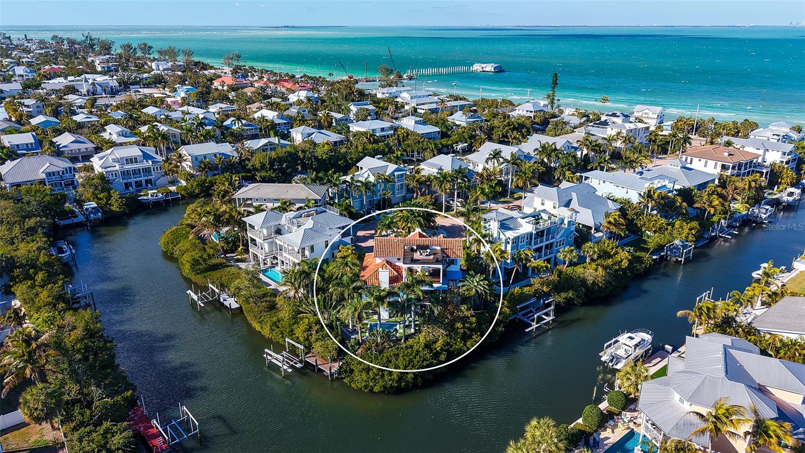 Rarely does a home of this architectural distinction and waterfront presence become available on Anna Maria Island. Tucked within the private residential enclave of Villa Rosa, this custom-built coastal estate offers a level of craftsmanship, privacy, and lifestyle reserved for the island’s most exceptional properties. Inspired by timeless European architecture, the residence is defined by reclaimed wood beams, marble flooring, handcrafted millwork, and curated designer finishes that create interiors both refined and welcoming. The chef’s kitchen serves as the heart of the home, featuring a statement Lacanche range, Sub-Zero refrigeration, custom cabinetry, and an expansive island designed for gathering and entertaining. Outdoor living unfolds as a private resort experience. A fully equipped Lynx outdoor kitchen, built-in pizza oven, covered lounge with wood-burning fireplace, and multiple terraces create effortless spaces for entertaining or quiet retreat. The rooftop observation terrace offers panoramic island views and becomes the perfect setting to watch sunsets paint the sky over the Gulf. Surrounded by lush tropical landscaping, the private pool and grounds evoke the feeling of a secluded coastal sanctuary. Positioned on a protected deep-water canal with direct, bridge-free access to Tampa Bay and the Gulf of Mexico, the private dock and 10,000-pound lift allow boating to become part of everyday life. Villa Rosa is one of Anna Maria Island’s most desirable residential communities, where rental restrictions preserve a quiet, private neighborhood atmosphere free from transient turnover. Just moments away, residents enjoy world-renowned powder sand beaches, waterfront dining at iconic destinations, boutique shopping along Pine Avenue, and the relaxed coastal lifestyle that defines Anna Maria Island. This is more than a home. It is a rare opportunity to own one of the island’s most architecturally significant and lifestyle-driven waterfront residences. Matterport tour is available.