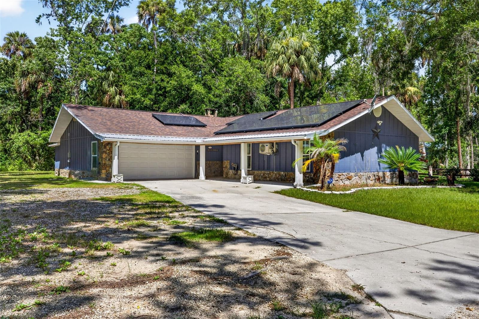 Welcome to your own private Florida retreat, where modern updates, outdoor living, and Old Florida charm come together on nearly half an acre in one of Homosassa's most desirable private waterfront communities.

This beautifully updated 3-bedroom, 2-bath ranch-style home offers the perfect blend of comfort, functionality, and lifestyle. Inside, you'll find a bright, open-concept floor plan designed for both everyday living and entertaining. The stunning chef-inspired kitchen features an oversized granite island, custom solid hickory cabinetry, stainless steel appliances, stone countertops, abundant prep space, and a spacious dining area that's perfect for gathering with family and friends. Rich stained and stamped concrete flooring flows throughout the main living areas, while a versatile flex room provides endless possibilities as a home office, guest room, fitness space, or hobby room.

Step outside and discover your own backyard oasis. Relax beneath the custom pergola, entertain at the outdoor bar and patio, gather around the fire pit under the stars, or simply enjoy the peaceful wooded surroundings. There's plenty of room for all your toys with a dedicated RV pad featuring full hookups, an attached two-car garage, additional carport, utility shed, and ample parking for boats, trailers, and recreational vehicles.

This home has been thoughtfully upgraded with new Pella windows (2024), solar panels, multiple new mini-split A/C units, gutter guards, and numerous energy-efficient improvements that provide lasting comfort and savings.

One of the standout features of this property is the private dock access, located just a short walk away. Launch your boat, kayak, or paddleboard with ease, spend your days fishing, or watch gentle manatees swim through the crystal-clear spring-fed waters. Exclusive community water access makes it easy to embrace the laid-back Florida lifestyle every day.

Looking for an investment? This property is currently operating as a successful short-term rental and is booked on Airbnb and VRBO nearly every weekend, providing excellent cash-flow potential for investors or buyers looking to offset ownership costs while still enjoying the home themselves.

Even more opportunity awaits, as the adjacent lot at 4626 S Flambeau Loop is also available for purchase, giving buyers the rare chance to expand their property, add additional privacy, build another home, or create the ultimate Homosassa retreat.

Perfectly located just minutes from local marinas, waterfront restaurants, shopping, hiking trails, and the world-famous Homosassa Springs, you'll also enjoy convenient access to Tampa, Ocala, Orlando, and Florida's beautiful Nature Coast.

Whether you're searching for a full-time residence, vacation getaway, income-producing investment property, or all three, this exceptional home offers an unmatched combination of lifestyle, location, and opportunity.

Schedule your private showing today and experience everything this incredible Homosassa property brings!