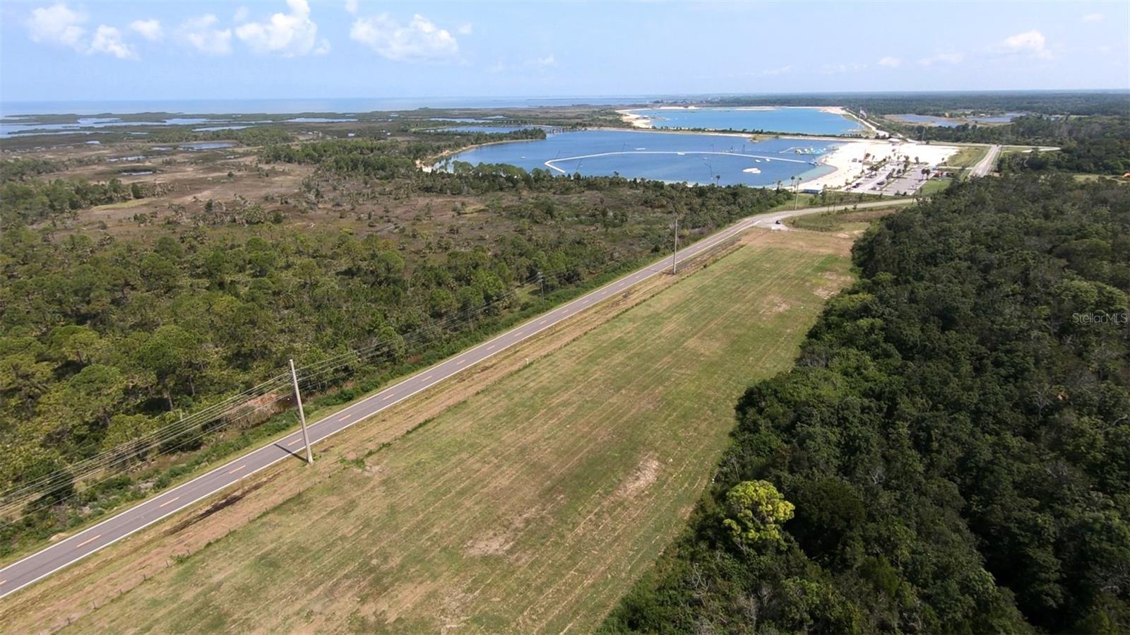 BEACH WEST — COMMUNITY & DEVELOPMENT OVERVIEW
An Exclusive Gulf-Front Enclave Within the SunWest Master-Planned Community
Beach West is a premier coastal hamlet located within the expansive SunWest development along Florida’s Gulf of America corridor. Positioned on the westernmost edge of the master plan, Beach West combines privacy, exclusivity, and direct access to the significant residential, marina, and recreational amenities that define the larger SunWest vision.
As a standalone enclave, Beach West benefits from the momentum of a rapidly evolving waterfront district while offering developers one of the most dynamic vertical development opportunities on the Gulf Coast.
Positioning of Beach West Within the Master Development
Beach West sits at a strategic gateway to SunWest, directly adjacent to the future Harbourtowne marina community and within close proximity to the already thriving SunWest Park. Its Gulf-facing orientation, unobstructed view corridors, and access to existing recreational infrastructure create a natural foundation for vertical residential development.
While the initial pro forma scenario envisioned a conservative 135-unit condominium concept, all future development at Beach West is intended to be vertical construction. This approach leverages the site’s strengths and unlocks a wide range of density possibilities. With no height restrictions currently in place, Beach West is capable of supporting well in excess of 400 units, allowing for the creation of multiple high-rise residential towers.
This vertical development pathway maximizes Gulf views, enhances long-term absorption, and provides developers extraordinary flexibility in phasing, scale, and architectural design. The ability to expand from a 135-unit scenario to a 400+-unit high-rise community significantly elevates the site’s highest and best use, establishing Beach West as a flagship residential opportunity within the SunWest ecosystem.
Integration With the SunWest Harbourtowne Vision
Beach West is uniquely positioned on the edge of the planned SunWest Harbourtowne — a world-class marina and waterfront village that will anchor the district. The Harbourtowne vision includes:
A 500-unit marina village offering a vibrant coastal lifestyle
Extensive wet slips capable of accommodating a broad range of vessels
Large dry storage facilities serving boaters, anglers, and recreational users
Retail, dining, boutique services, and walkable mixed-use components
Seamless connectivity to Beach West as an elevated residential counterpart
As Harbourtowne develops, Beach West will serve as the luxury residential complement to the marina-driven waterfront core, greatly enhancing value, demand, and identity for both communities.
SunWest Park — A Major Existing Amenity & Destination
One of the most compelling advantages of Beach West is the immediate presence of SunWest Park, an established public waterfront recreation area drawing residents and visitors year-round. Key features include:
A white-sand lagoon-front beach
Wakeboarding and paddleboard facilities
Active event programming and seasonal attractions
Strong regional brand recognition