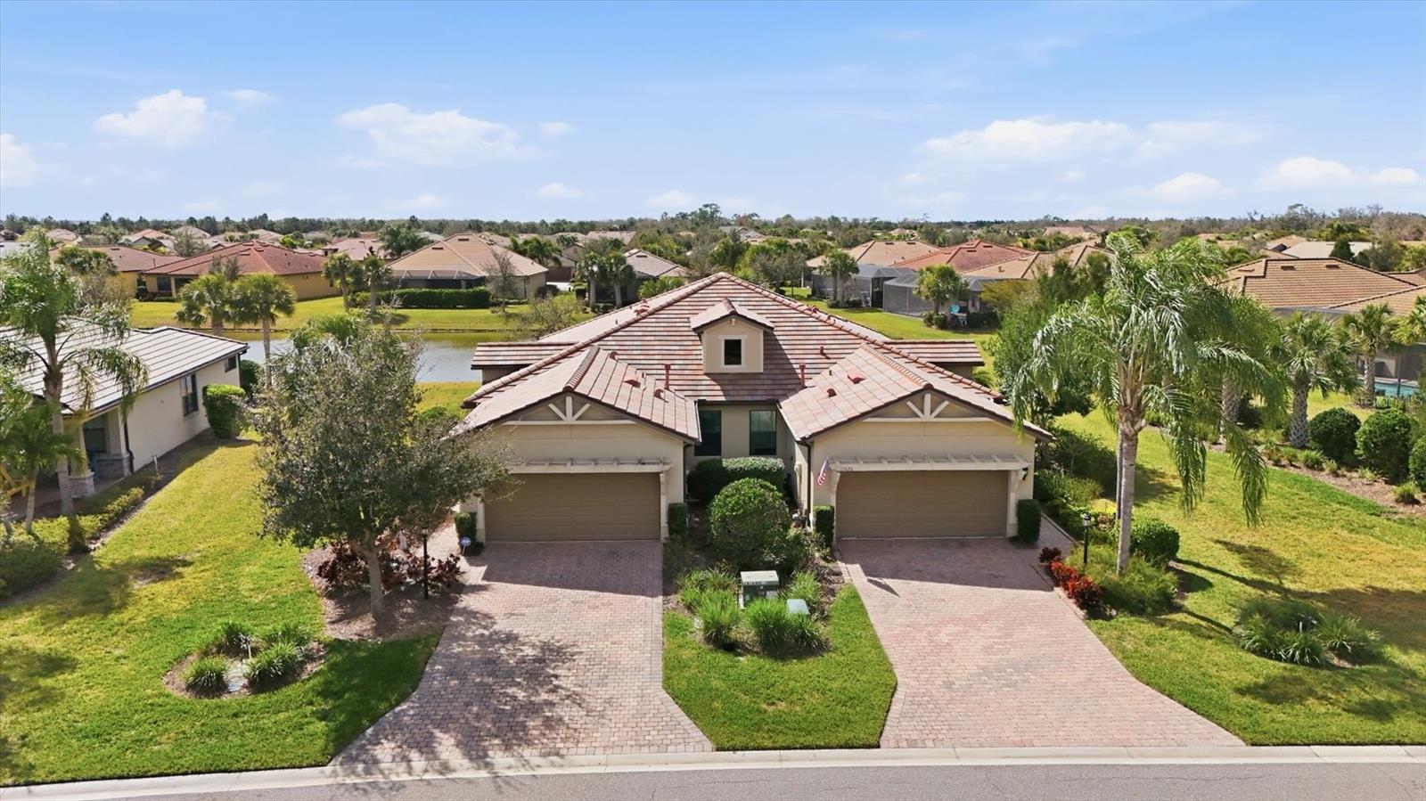 Wake up to water views in this beautiful paired villa in Del Webb at Lakewood Ranch. Enjoy the convenient access at the end of the cul-de-sac to the path leading directly to the clubhouse and resort-style amenities. Offered furnished, this residence is well maintained and has 2 bedrooms plus a spacious office adding flexibility for a 3rd bedroom. Designed with an open-concept layout, the main living areas feature ceramic tile flooring and flow seamlessly toward the water. The kitchen has granite counters, a bar and a pantry. The primary bedroom has water views and an en-suite bathroom with dual sinks, shower, walk-in and linen closets, and a water closet. The second bedroom has a large walk-in closet and is adjacent to the second bathroom. The inside laundry room has plenty of storage and hosts a utility sink. Enjoy quiet mornings on the cozy screened lanai overlooking the water before heading out to enjoy your new lifestyle in the premier 55+ pet friendly community of Del Webb. The amenities include an abundance of social activities, pools, a restaurant, live music, tennis, pickleball, bocce ball, fitness center, and an impressive array of amenities designed for active living. Take advantage of peaceful common area walking trails set along scenic ponds and enjoy the ease of a golf cart friendly community. Endless opportunities to stay active and social, with everything you need to live well and stay engaged. Vibrant lifestyles just beyond your front door includes farmers markets, live music, boutique shopping, and waterfront dining. Easy access to I75, UTC Mall, Waterside, downtown Sarasota and Bradenton, Gulf Coast’s award-winning beaches and medical facilities. This is Lakewood Ranch living, done beautifully.