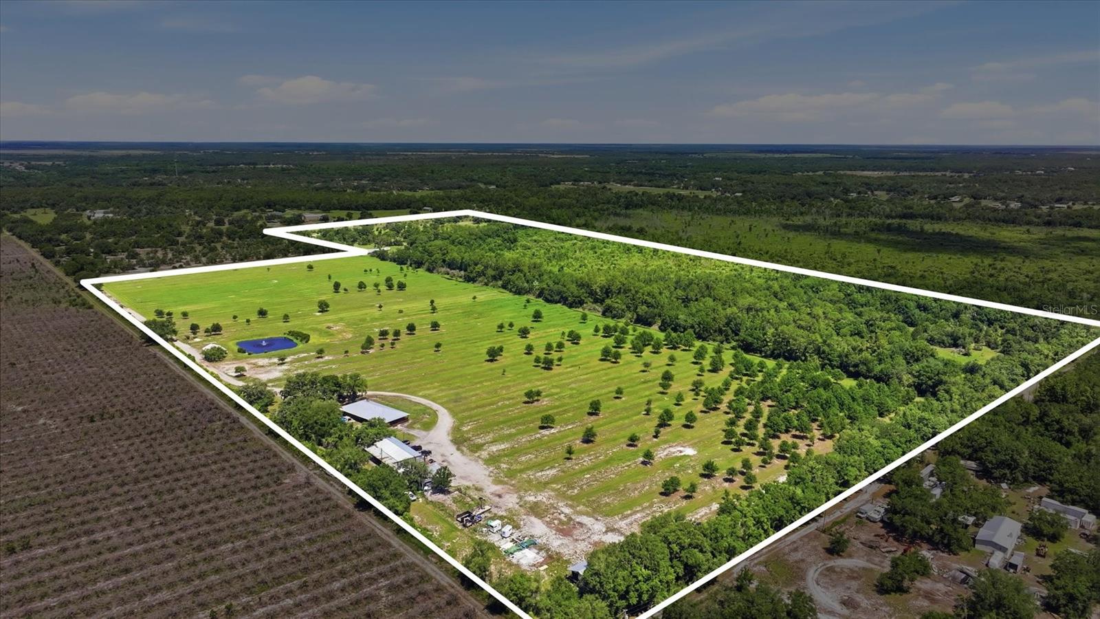 MAGNIFICENT MYAKKA RANCH ESTATE! Rarely does a property deliver this level of privacy, usability, infrastructure, and natural beauty in one offering. Set on approximately 105 ACRES INCLUDING THE PRIVATE ROAD, this exceptional estate blends open pasture, wooded privacy, and ranch-ready improvements into one truly special Florida retreat. Tucked well off Wauchula Road, the custom John Fultz-built cedar ranch home captures timeless country character with a FULL WRAPAROUND PORCH, where one can sit sipping on a cup of their favorite brew whilst taking in the serene views of wide-open pasture, mature oaks, wildlife, and peaceful acreage. Inside, the home offers an inviting open layout anchored by warm gathering spaces, an updated kitchen with solid wood cabinetry, granite surfaces, a large center island, and a comfortable flow for everyday living or entertaining. A separate oversized living/flex room provides ideal space for a home office, media room, gym, studio, guest space, or multi-purpose retreat. The private owner’s retreat features serene acreage views and a beautifully remodeled bath with a walk-in rain shower. At the same time, the home also offers fiber-optic internet, a durable metal roof, 3-zone A/C, a water softener, PROPANE SERVICE, and electric wiring flexibility for major appliances. Recent improvements include NEW PGT IMPACT WINDOWS and exterior cedar washed and resealed in 2026. A commercial 100 kW DIESEL GENERATOR is also on site. The land is where this property truly separates itself. TWO FENCED PASTURES, cross-fenced acreage, a FOUR-STALL OPEN-AIR HORSE BARN, spray-foamed enclosed barn with its own A/C, multiple electric meters, RV hookups, a 375-ft house well, and a 1,300-ft PERMITTED IRRIGATION WELL create tremendous utility for ranching, equestrian use, agriculture, equipment storage, or recreational living. The oversized garage/workshop setup provides extensive space for vehicles, tools, equipment, hobbies, or business-related storage, adding even more versatility to the property. The open pasture affords new owners ample agricultural potential, whether one wants to plant, run cattle, board and train horses, establish a hobby farm, or simply create a private country retreat, while the LARGE STOCKED POND with bream and catfish offers fishing, swimming, and a peaceful centerpiece to the property. The above-ground pool with surrounding deck creates another place to unwind after a day on the land, while the open acreage, mature tree canopy, and frequent wildlife sightings reinforce the privacy and calm that make this estate so special. With NO HOA, abundant wildlife, barns, outbuildings, pasture, privacy, and room to breathe, this is the kind of property that supports a true ranch, equestrian, agricultural, recreational, or private family compound lifestyle. Located near TerraNova Equestrian Center, Soleta Golf Club, Myakka City Tavern, Silver Star East, Lakewood Ranch, Sarasota, Siesta Key Beach, Lido Key Beach, and Anna Maria Island, this is a rare chance to own a legacy property in the heart of Myakka City. OPPORTUNITIES LIKE THIS ARE ONCE IN A LIFETIME! DO NOT ALLOW THIS MAGNIFICENT MYAKKA RANCH ESTATE TO RIDE OFF INTO THE SUNSET WITHOUT YOU!