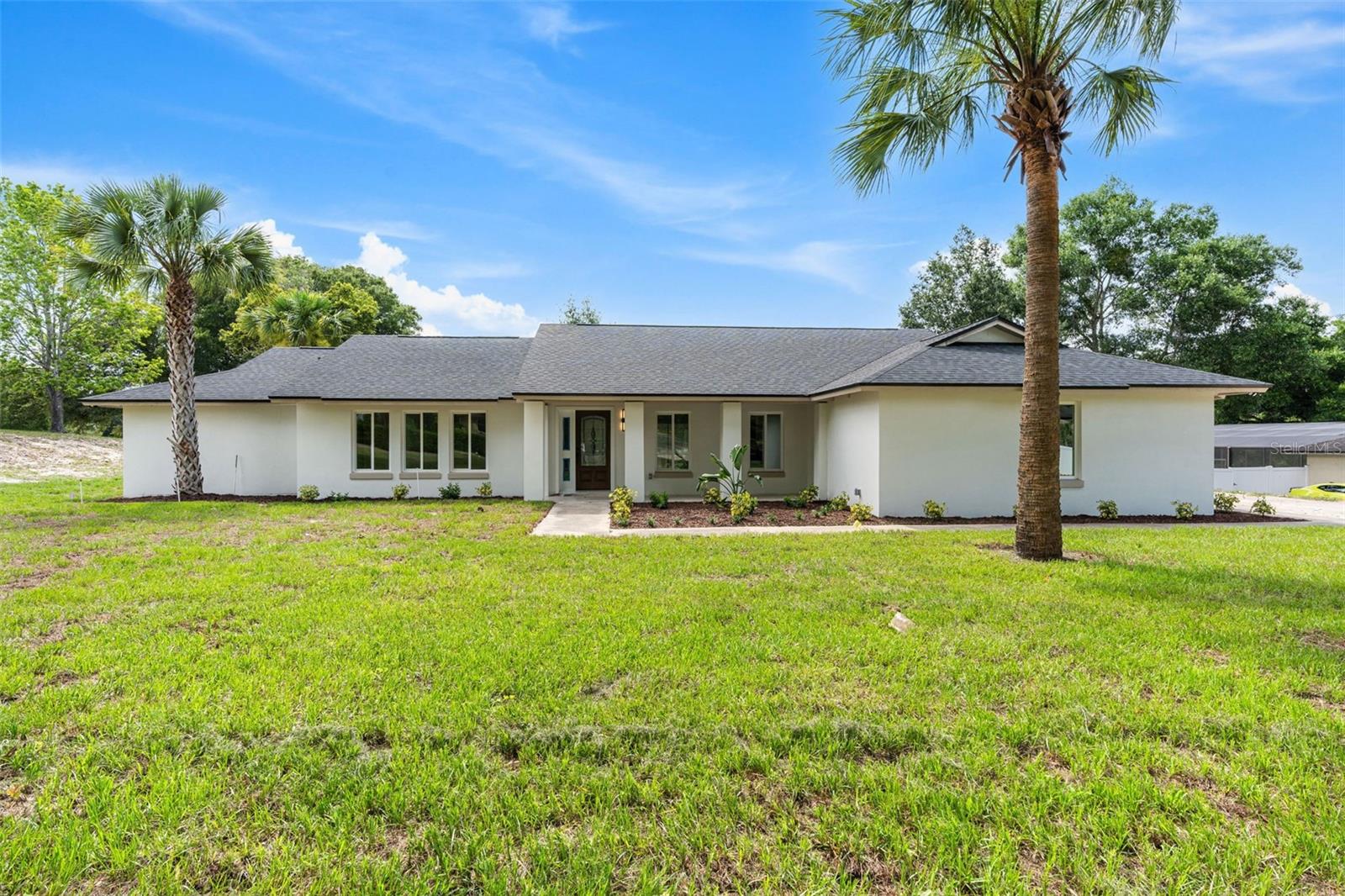Situated on more than an acre of fully fenced land with no HOA, this completely reimagined Longwood estate offers a rare combination of privacy, luxury, and modern convenience. Thoughtfully renovated from top to bottom, the home showcases exceptional craftsmanship and extensive improvements including a new roof, new windows, complete repiping, a new water heater, resurfaced pool, updated lighting, and fresh landscaping with new sod throughout the property.

Inside, soaring vaulted ceilings with exposed beams create a dramatic first impression, while expansive living spaces filled with natural light offer the perfect balance of sophistication and comfort. The designer kitchen serves as the centerpiece of the home, featuring custom cabinetry, quartz countertops, premium finishes, and seamless flow into the surrounding living and dining areas. Every detail has been carefully curated to deliver a truly turnkey living experience.

The primary suite provides a private retreat, while beautifully updated secondary bedrooms and baths offer comfort and flexibility for family and guests. Walls of glass invite the outdoors in, overlooking the resort-style backyard designed for year-round enjoyment.

Outside, the resurfaced pool is surrounded by sprawling grounds that provide exceptional privacy and endless possibilities. Whether hosting gatherings, storing recreational vehicles, creating a garden oasis, or simply enjoying the freedom that comes with owning over an acre of land, this property offers a lifestyle rarely found in today's market. Fully fenced and free from HOA restrictions, the estate delivers the space, privacy, and flexibility discerning buyers desire without sacrificing convenience to top-rated Seminole County schools, dining, shopping, and major commuter routes.

A rare turnkey estate offering where every major improvement has already been completed, allowing the next owner to simply move in and enjoy.