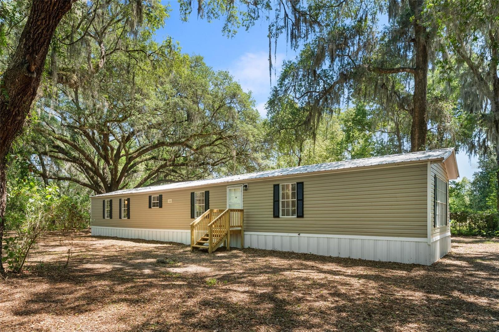 Welcome to this beautifully remodeled 3 bedroom 2 bathroom home situated on .44 acres. Nestled in a tranquil neighborhood, this serene location offers peace and privacy, making it an ideal spot to settle down and create your own haven. The home was fully remodeled in 2026 with high-end materials and craftsmanship. Step inside to discover a thoughtfully designed layout featuring a spacious living room perfect for both entertaining and relaxing, accented by natural light pouring in through windows. The kitchen features new stainless-steel appliances and ample cabinet storage. Adjacent to the kitchen, a laundry room with plenty of room for a washer, dryer, and extra storage racks. The primary bedroom is spacious and includes a walk-in closet. The primary bathroom has been fully remodeled, with a new vanity, soaker tub, and step-in shower. This home has a split floor plan, providing a living room and dining room perfect for entertaining and relaxing. On the other side of the home, there are two additional bedrooms and a fully remodeled bathroom, providing ample accommodation, luxury vinyl flooring, and ample closet space. These additional bedrooms provide versatility for guests. Numerous updates have been made in the last few years, including a full house remodel in 2026: new interior paint, exterior skirting, new vinyl flooring and trim, new 3-ton HVAC, new fans, stainless steel appliances, new doors, and both bathrooms fully remodeled. Additionally, the home has a newer covered metal roof. Outside, revel in the beauty of a fully fenced property with a new front deck and back steps. The property is mostly cleared land with some trees for added privacy. The property is conveniently located just 13 minutes from downtown Hawthorne and less than 30 minutes from Gainesville, which offers ample options for dining, shopping, and hospitals. This is a one-of-a-kind property, so call today to schedule a showing!