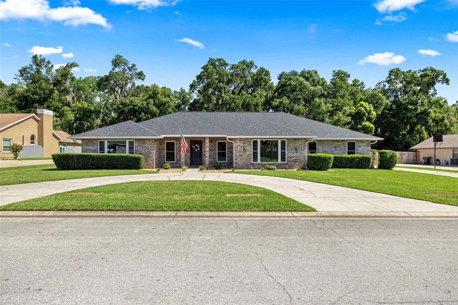 Welcome home to this beautifully maintained 5-bedroom, 3-bath pool home in one of SE Ocala's most desirable communities! Tucked among mature oaks just minutes from town, this spacious single-story residence blends timeless charm with room to live, entertain, and unwind. Step inside to soaring vaulted ceilings and an open, light-filled great room anchored by a stunning floor-to-ceiling brick wood-burning fireplace — the perfect gathering spot on cool Florida evenings, tile flooring flows throughout the main living areas, complemented by fresh designer paint and modern fixtures. Many updates include a roof and new HVAC in 2023, new windows in 2022 and the waterheater replaced in 2026.
The split floor plan offers five true bedrooms, giving everyone space to spread out — ideal for guests, a home office, or multigenerational living. But the real showstopper is out back: your own private oasis featuring a sparkling in-ground pool, expansive paver-accented patio, and covered lanai overlooking a huge fully fenced backyard with plenty of room to play, garden, or add whatever you can dream up. The curved driveway, brick-accented facade, and manicured landscaping deliver picture-perfect curb appeal on a quiet, established street.
All of this just minutes from shopping, dining, golf, and everything near downtown Ocala.  Homes like this — space, pool, location, and move-in ready condition — don't come along often. Schedule your private showing today!